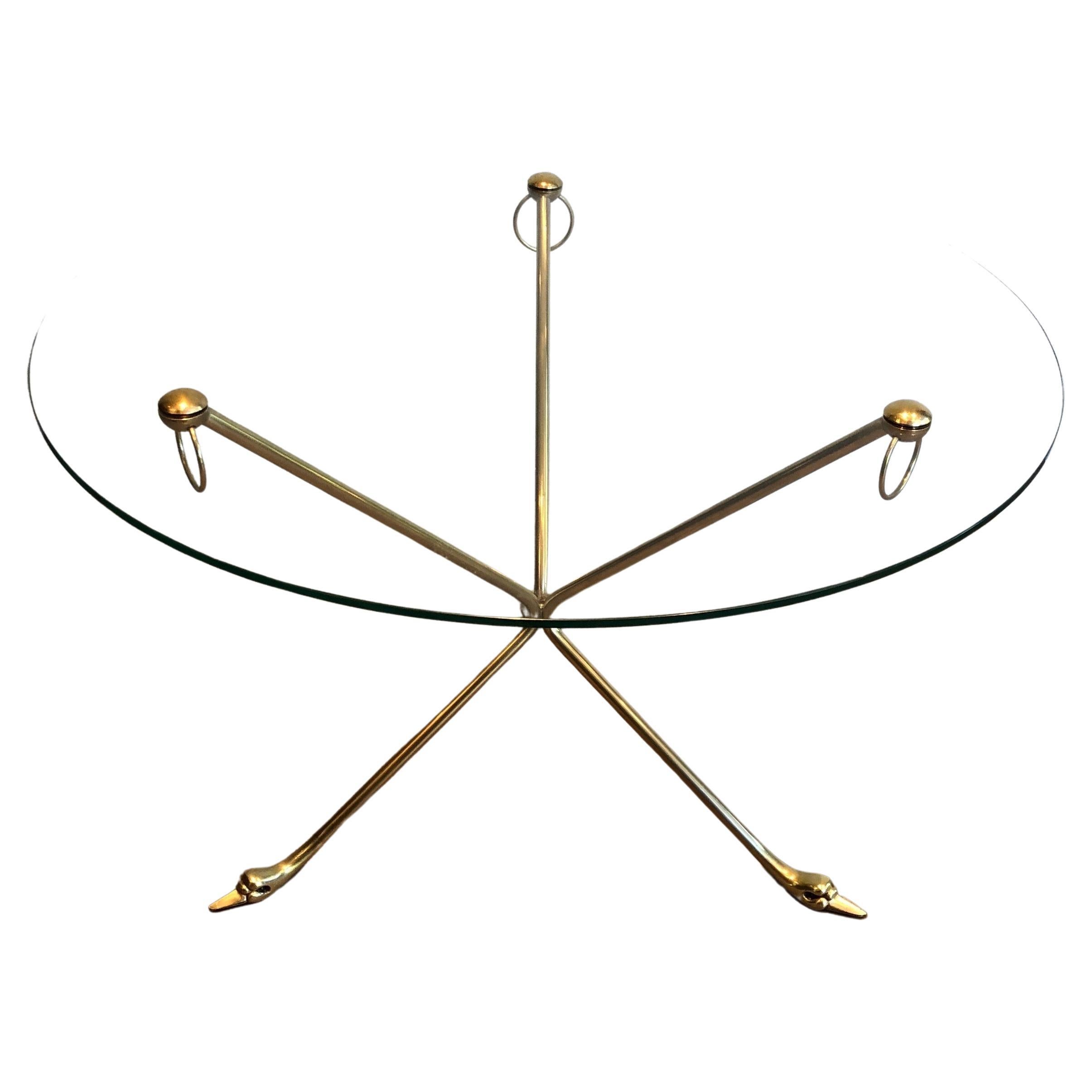 This very nice tripode swans coffee table is made of brass with a round glass top. This a work by famous french designer Maison Jansen. Circa 1940.