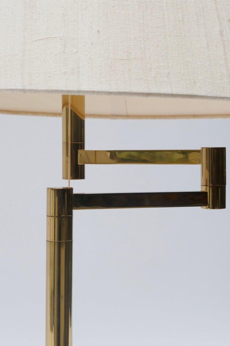 Large brass swing arm or adjustable table lamp, Germany, 1970s.
Perfect on a desk or by a sofa
Size without lamp shade
Height 73cm Base Diameter 25cm
Size with lampshade : 
Height 78cm, Diameter 80cm.
