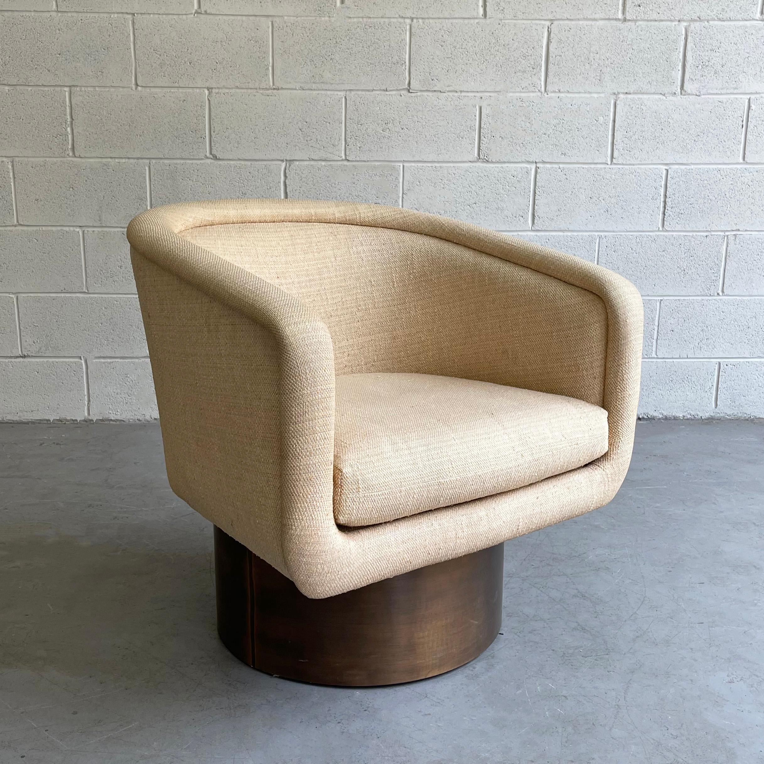 1970s, Mid-Century Modern, barrel, club chair by Leon Rosen for Pace with cream tweed upholstery swivels on a brass cylinder base.