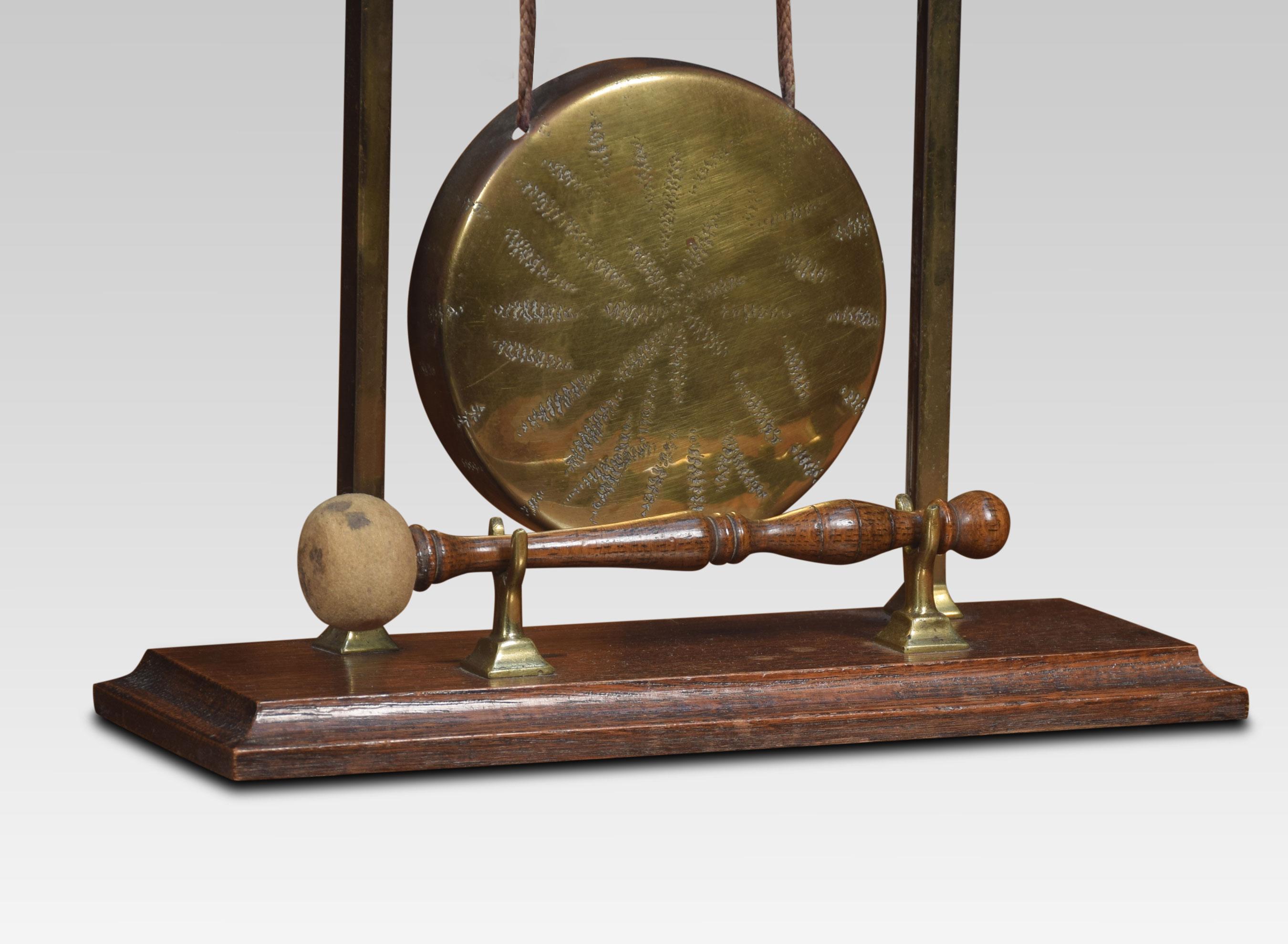 Brass table gong depicting a galleon above square supports supporting the original brass gong. All raised up on stepped oak base.
Dimensions
Height 13.5 inches
Length 11 inches
width 4 inches.