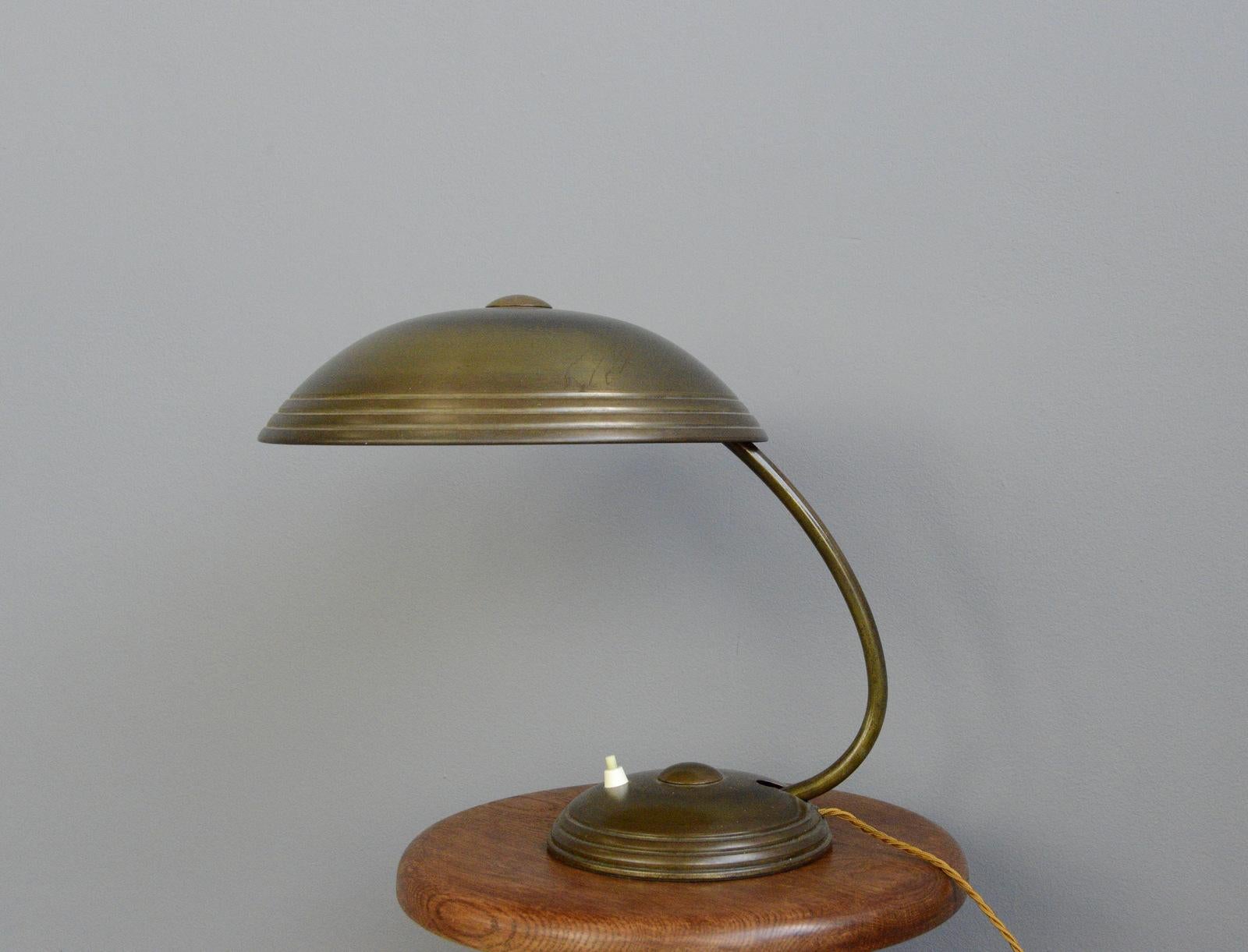 Brass table lamp by Helo, circa 1940s

- Solid brass arm, shade and base
- Original push button switch
- Takes E27 fitting bulbs
- Made by Helo, Nueberg
- German, late 1940s
- Measures: 35cm tall x 33cm wide x 43cm deep

Condition