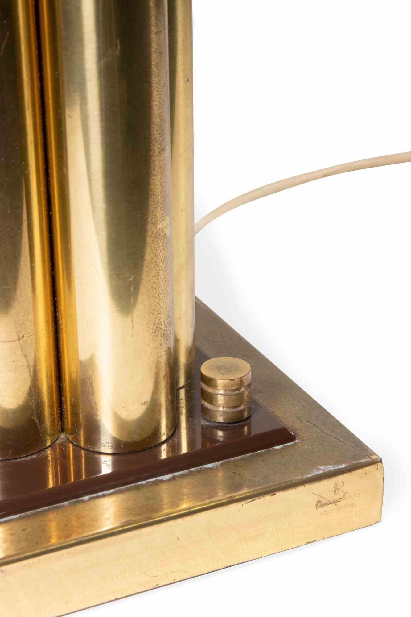 Brass table lamp is a mid-century design item realized in 1970s by  Romeo Rega  (1904-1968).

Brass and plexiglass lamp.

Signature 