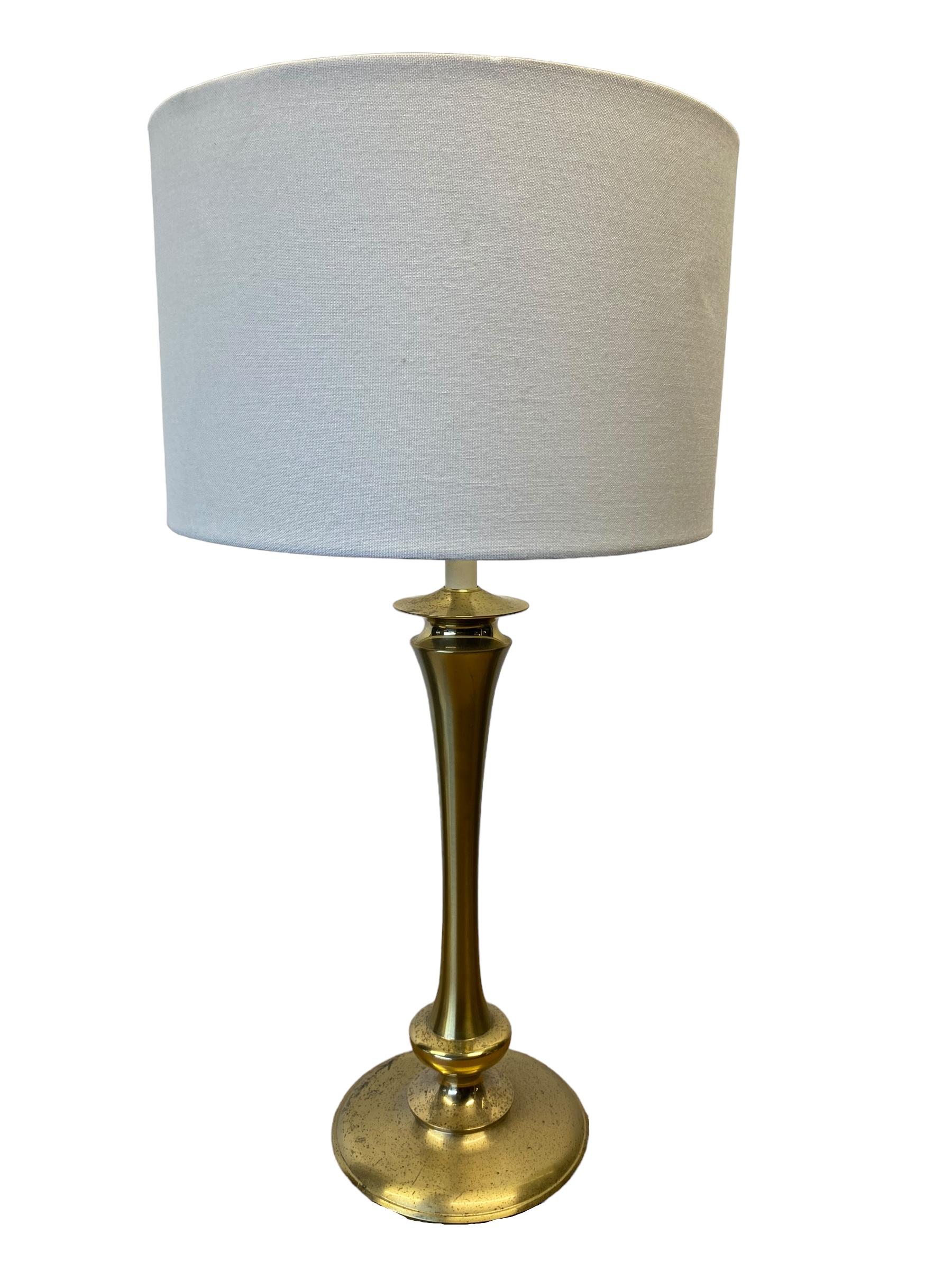 Vintage brass table lamp by Stiffel. Simple tulip form and turned base with candle stick fixture. Elegant example of mid century design. 