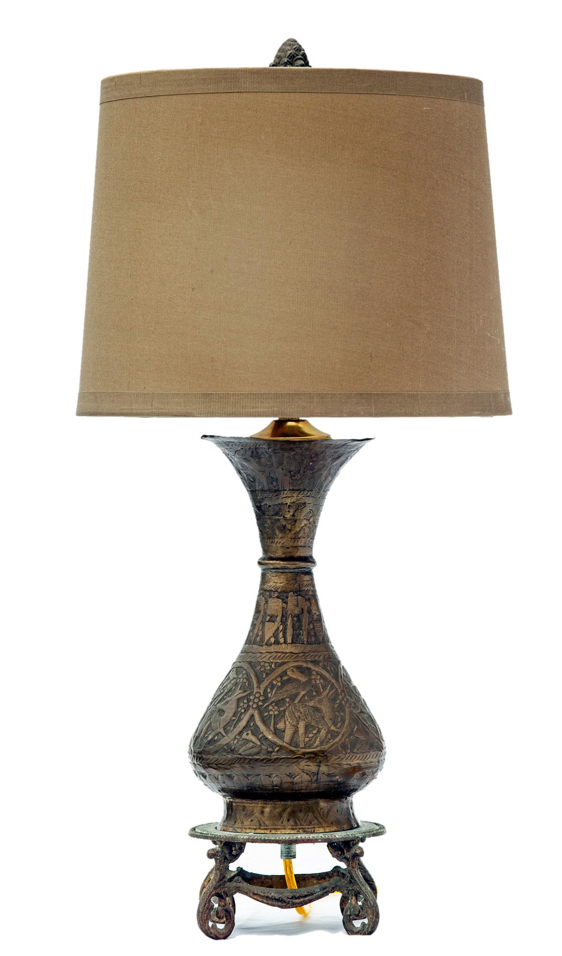 Finely etched Turkish antique brass vase mounted as a lamp, the vase sits on a white metal base.
The RH silk lampshade is new with no wear.