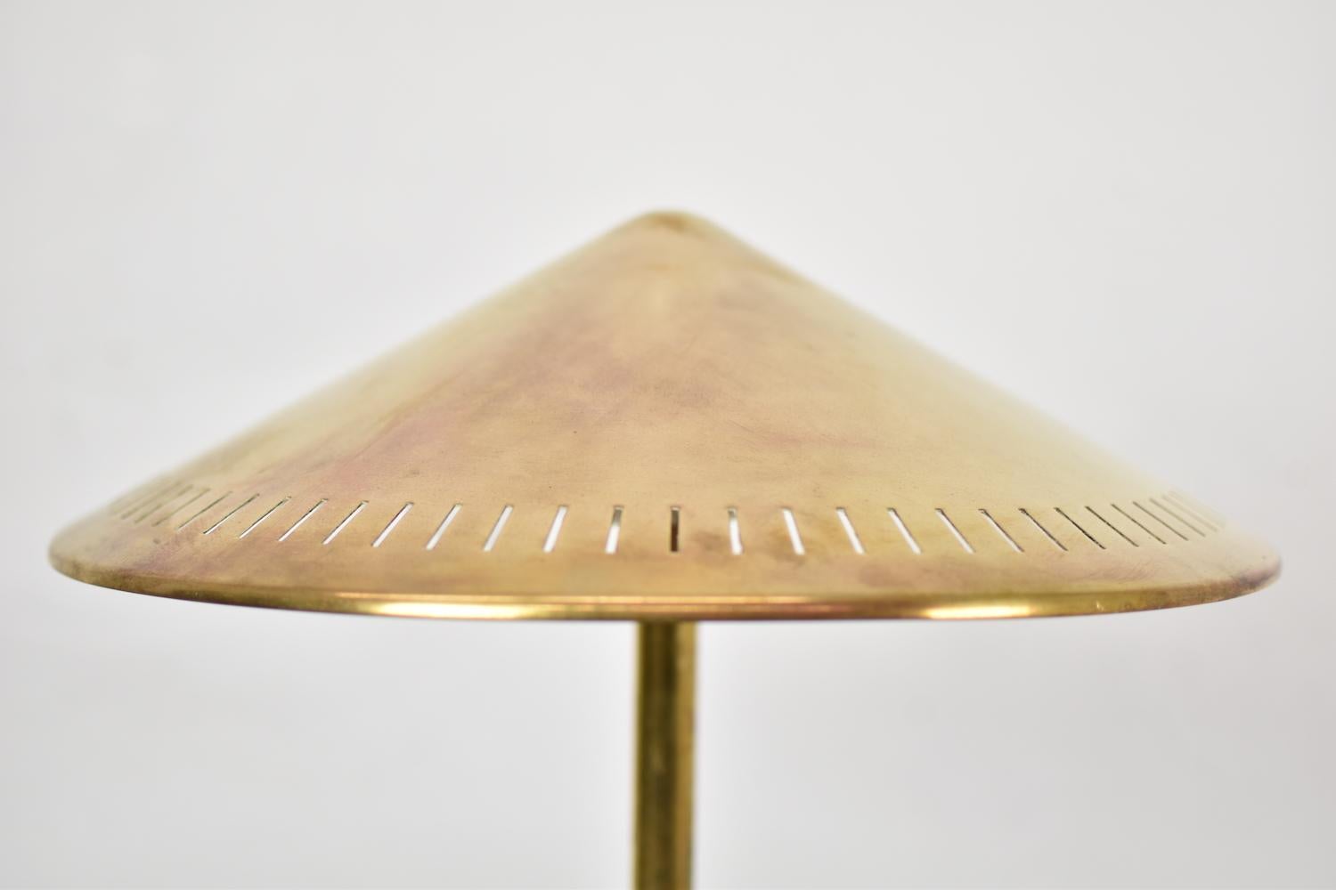 Lovely table lamp designed by Bent Karlby for Lyfa, Denmark, 1950s. This lamp is made out of solid brass and has a nice elegant conical-shaped perforated shade. Two light sources. Newly rewired.