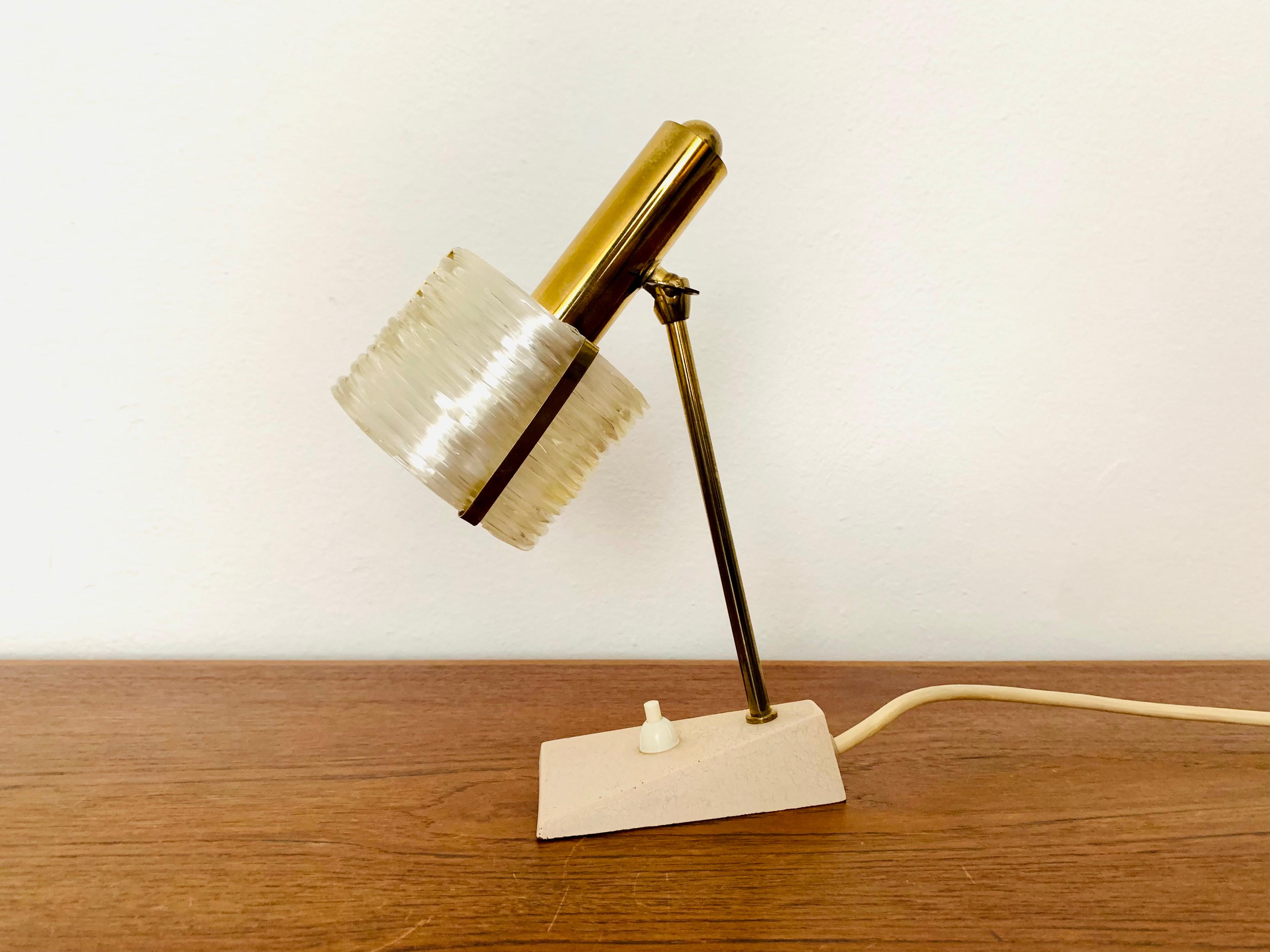 Very nice table lamp from the 1950s.
The extraordinary lampshade spreads a great glamorous and sparkling light.
An absolute eye-catcher in every home.

Condition:

Very good vintage condition with slight signs of wear consistent with age.
A very