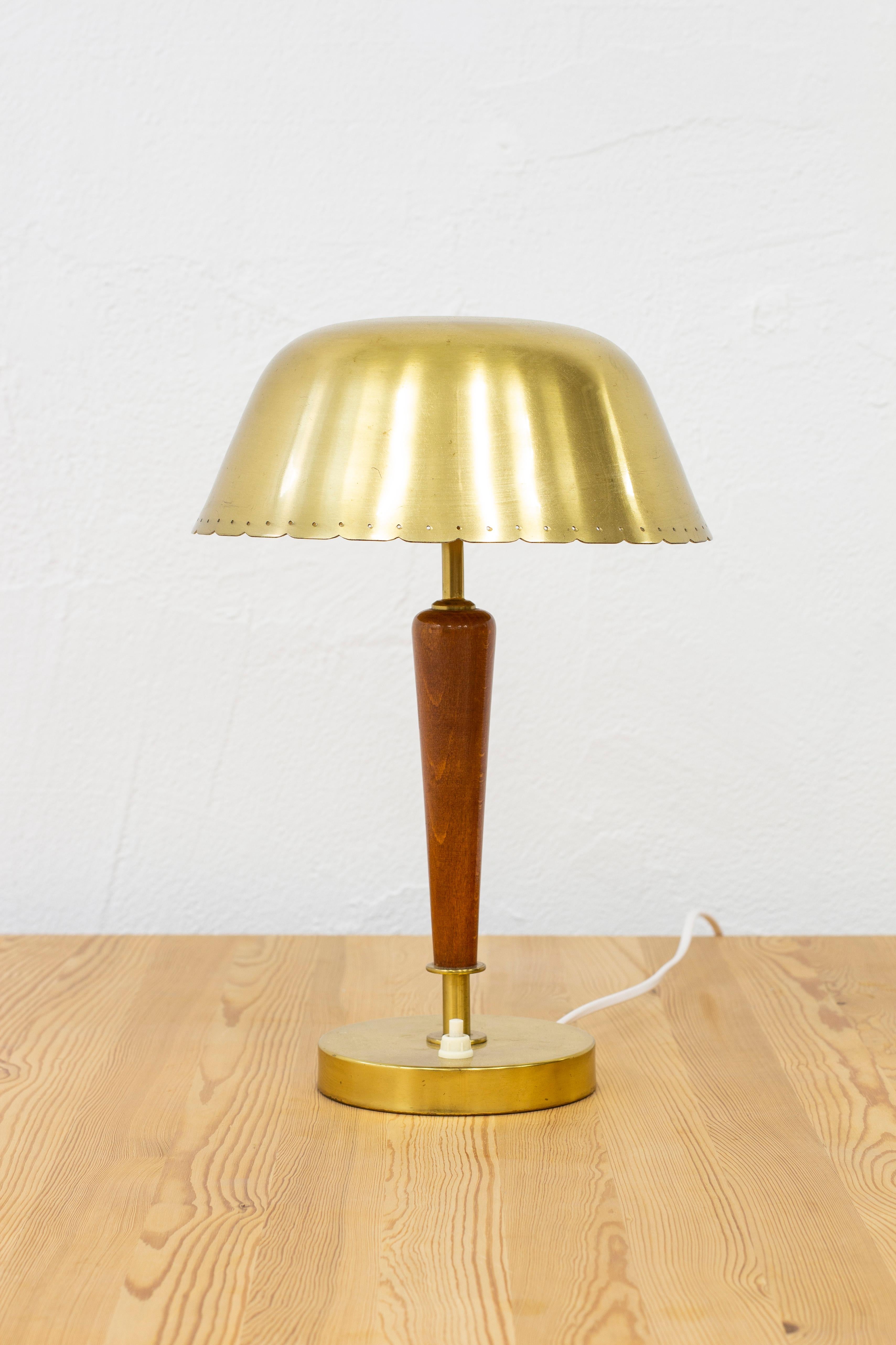 Table lamp designed and produced in Sweden, ca 1950s. Model number 1201, marked FNM. Made from brass and beech wood. Original light switch on the base in working order. Very good vintage condition with few signs of patina from age and use.

  
