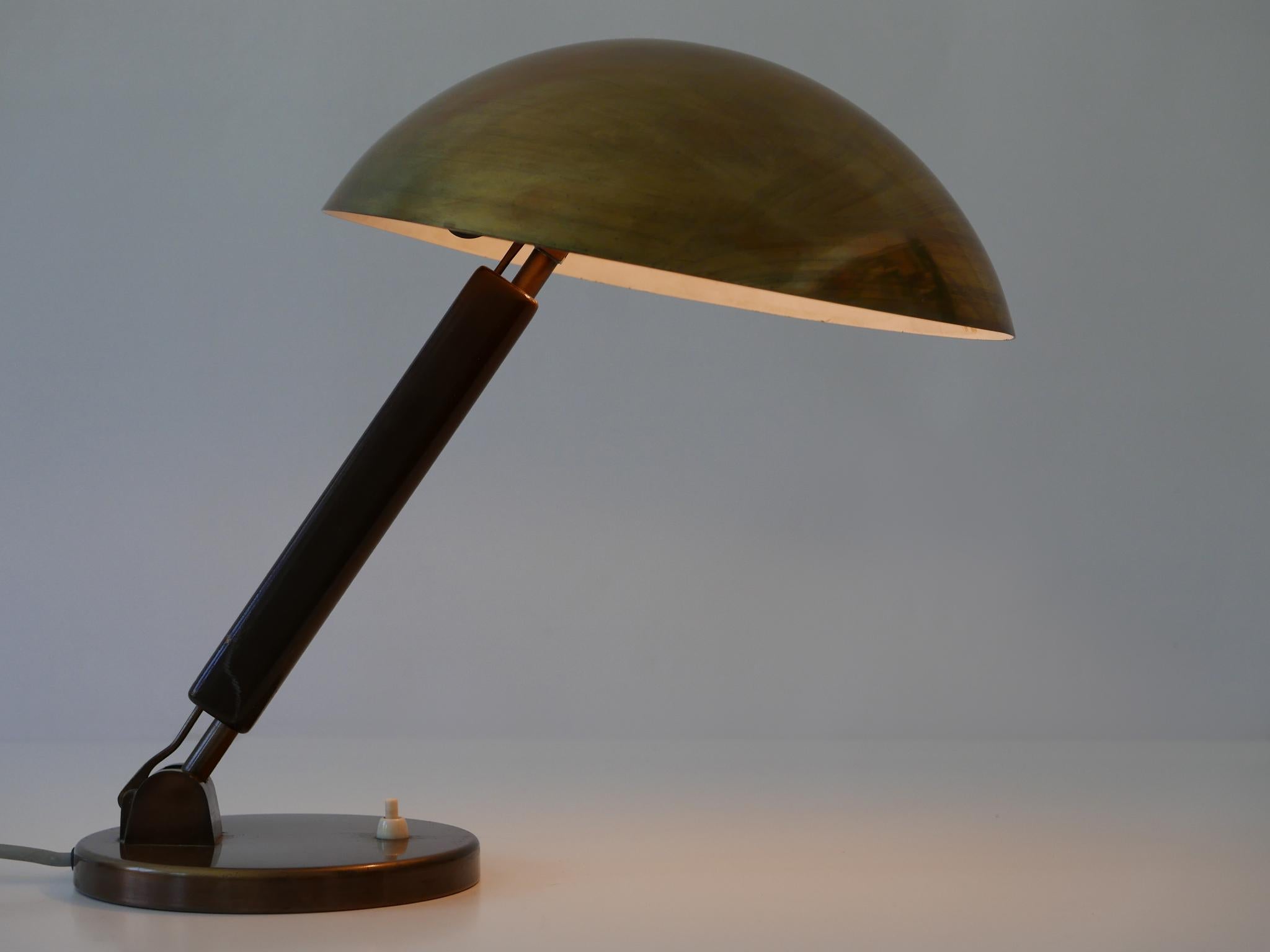 Exceptional and elegant Bauhaus / modernist table lamp or desk light. Designed by Karl Trabert for BAG Turgi, 1930s, Switzerland. Makers label inside the lamp shade.

Executed in brass and wood, the lamp comes with 1 x E27 / E26 Edison screw fit