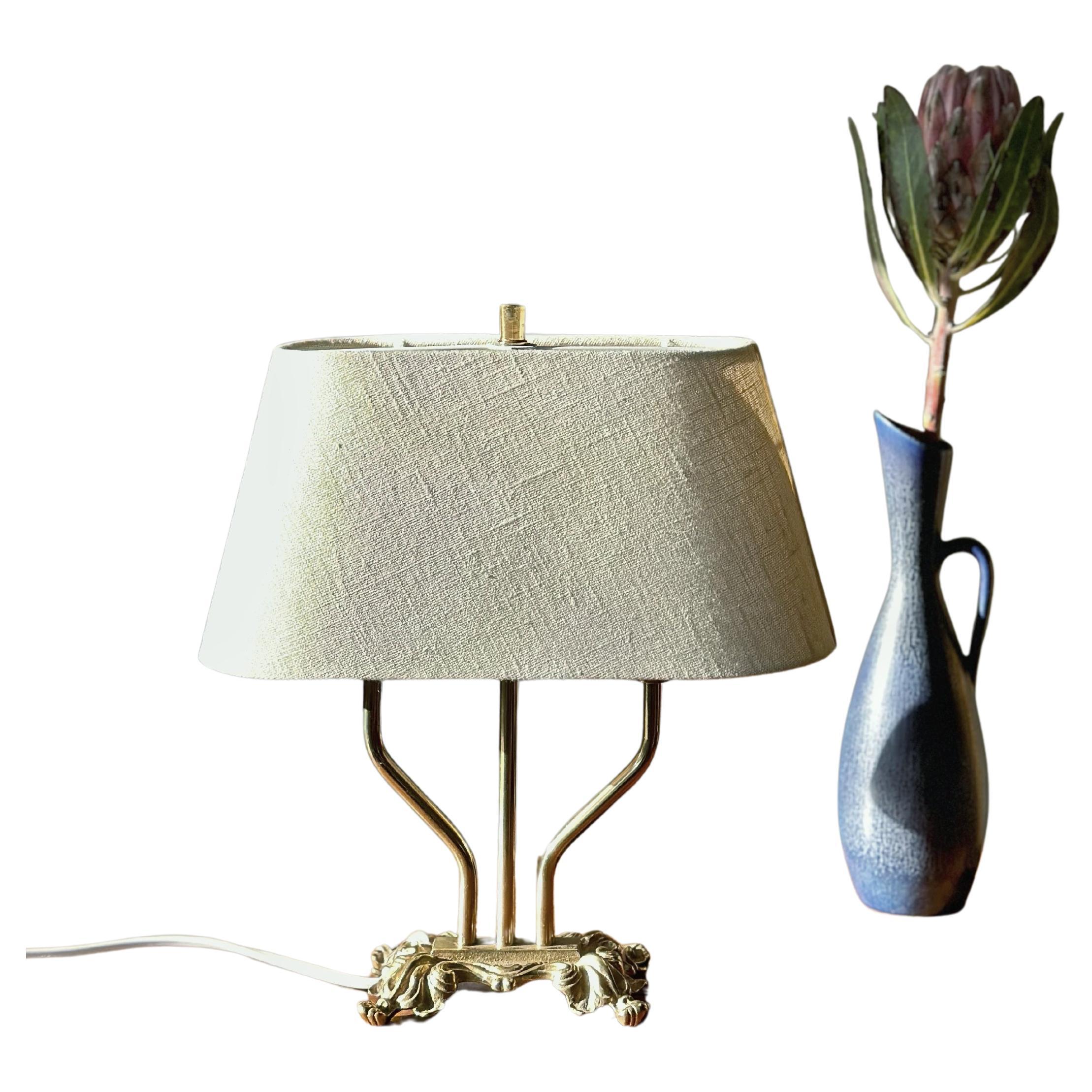 Classic Brass Table Lamp in Empire style with two arms. Sweden, 1940s. 

Original shade with new fabric in creme colored linen is included. 

Rewired with new cable & EU plug.

Great condition with only light signs of wear.


Measure: 
Height lamp