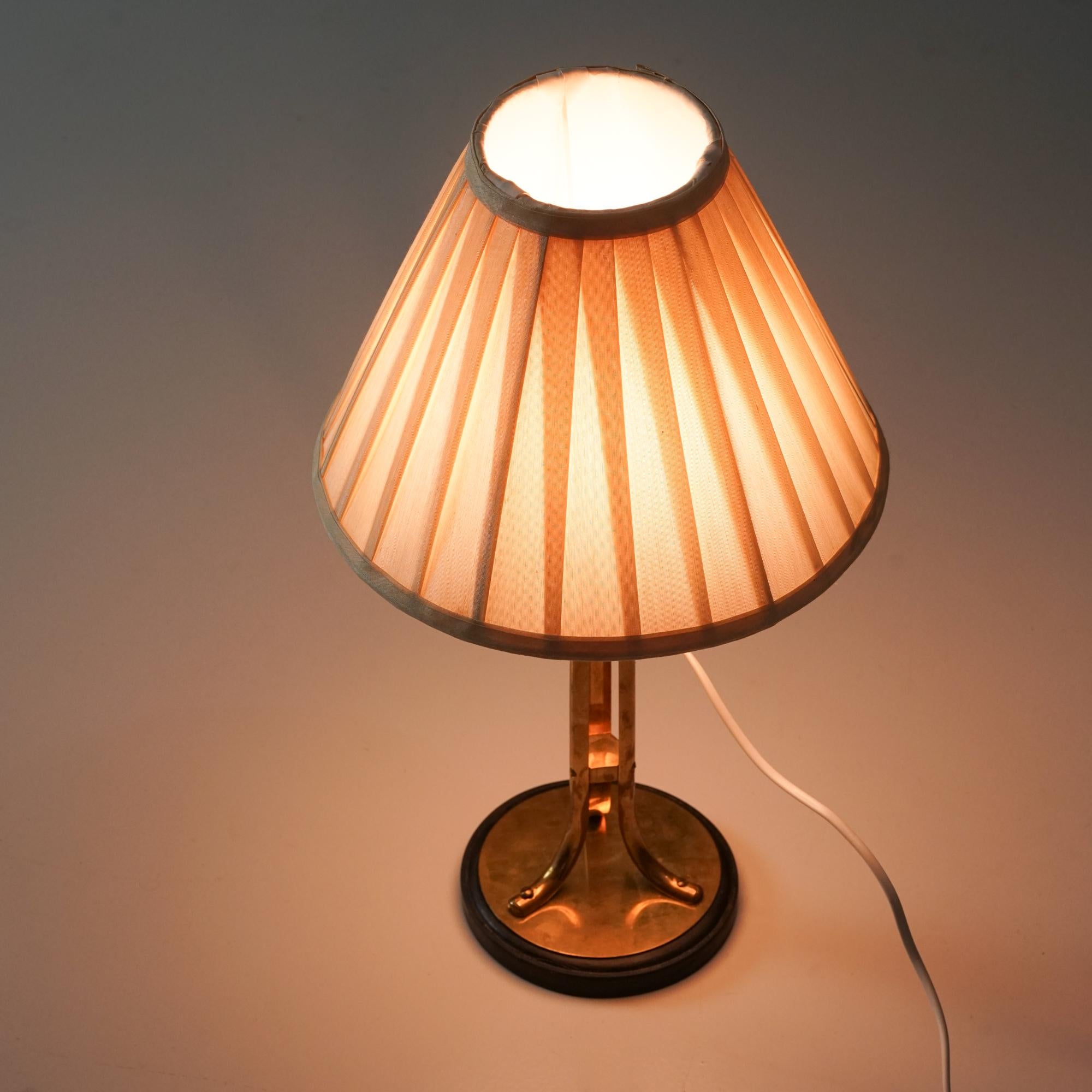 Brass table lamp, manufactured in Sweden, 1940/1950s. Brass and metal frame with fabric lampshade. Good vintage condition, patina consistent with age and use. Beautiful Scandinavian Modern design. 