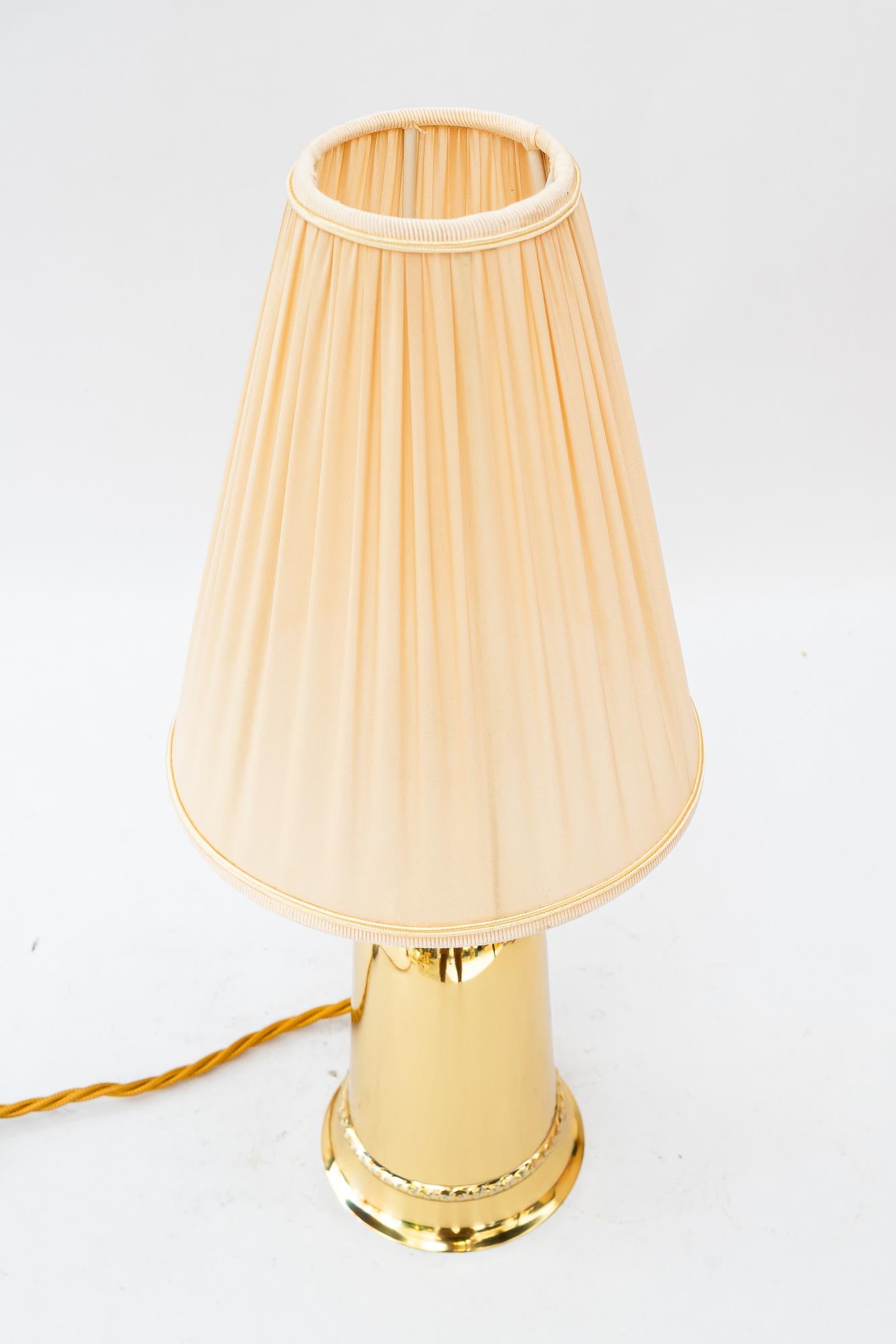 Brass table lamp with fabric shade vienna around 1960s
Brass polished and stove enameled
The fabric shade is replaced ( new )