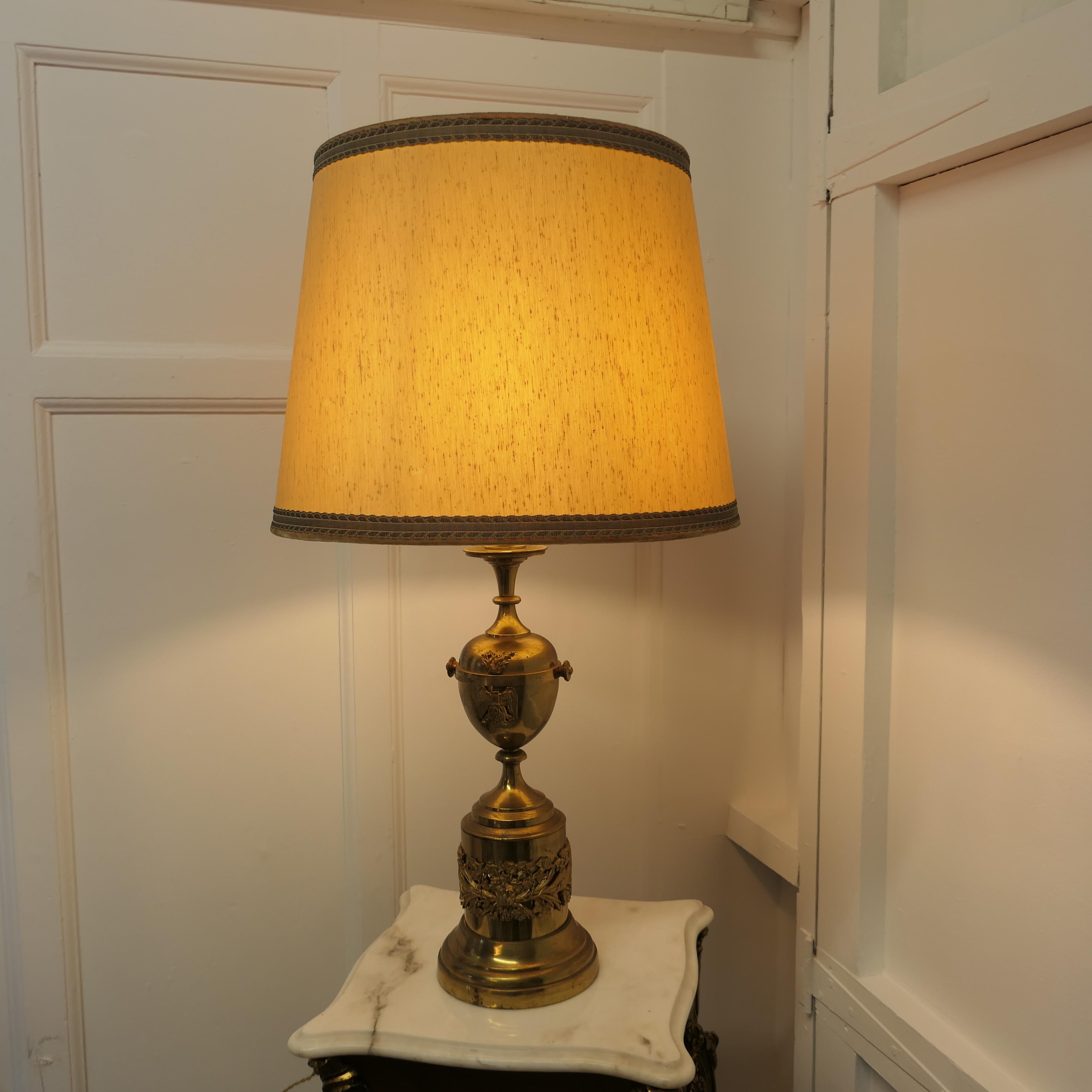 Brass Table Lamp with Italian Classical Mask and Mounts to the Base

This lamp is made in brass and it has a shaped bulbous column with classical Italian chased decorative mounts
The Lamp has its original silk shade and is measures 32” tall, 18” in