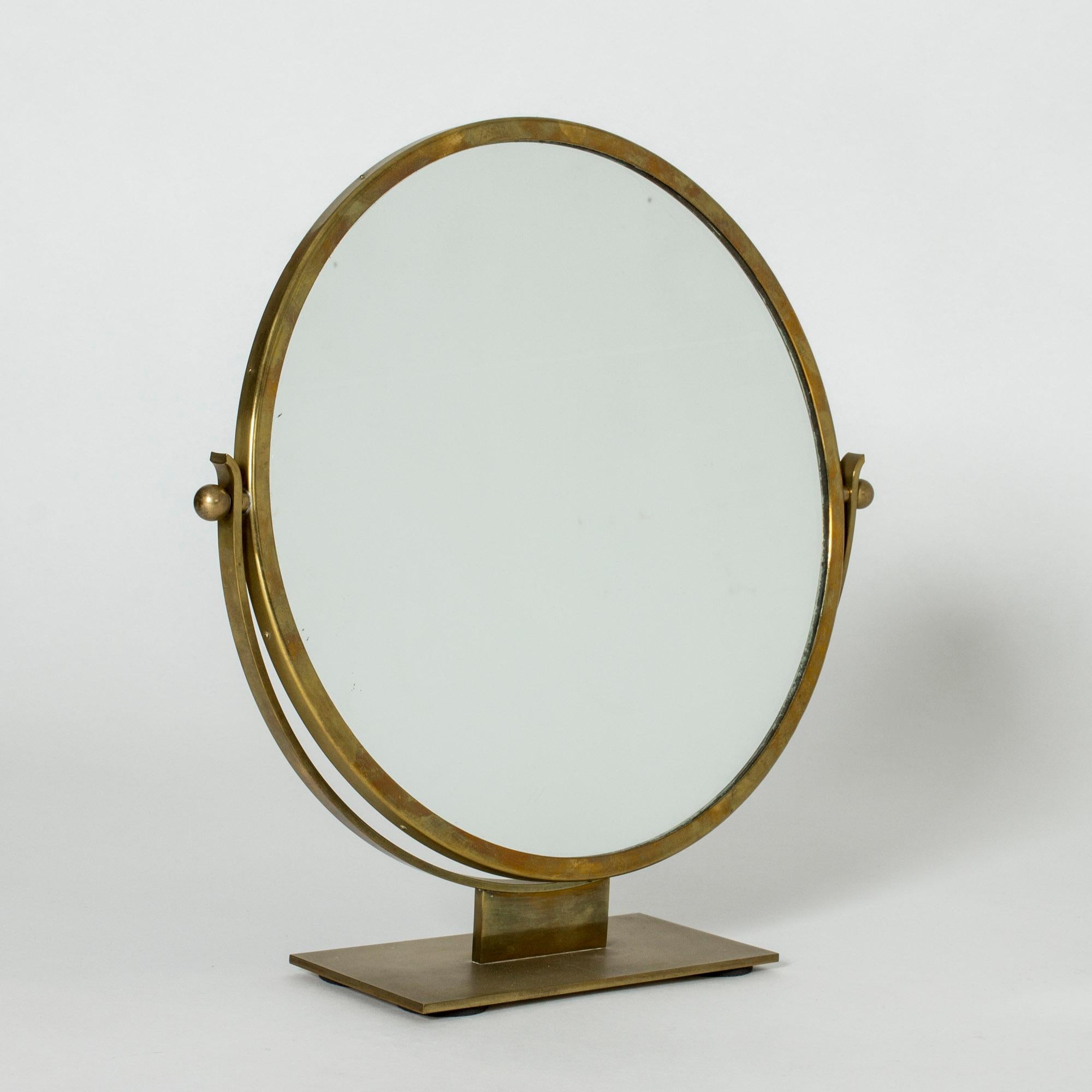 Beautiful functionalist table mirror by Ivar Ålenius-Björk, with strict lines. Made from brass.