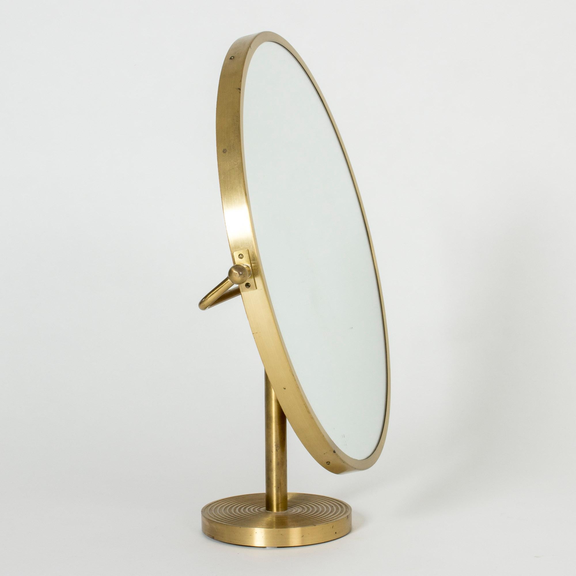 Oversized, round brass table mirror by Josef Frank. Clean, elegant lines. Beautiful embossed pattern of stripes on the base of the mirror, wooden back.