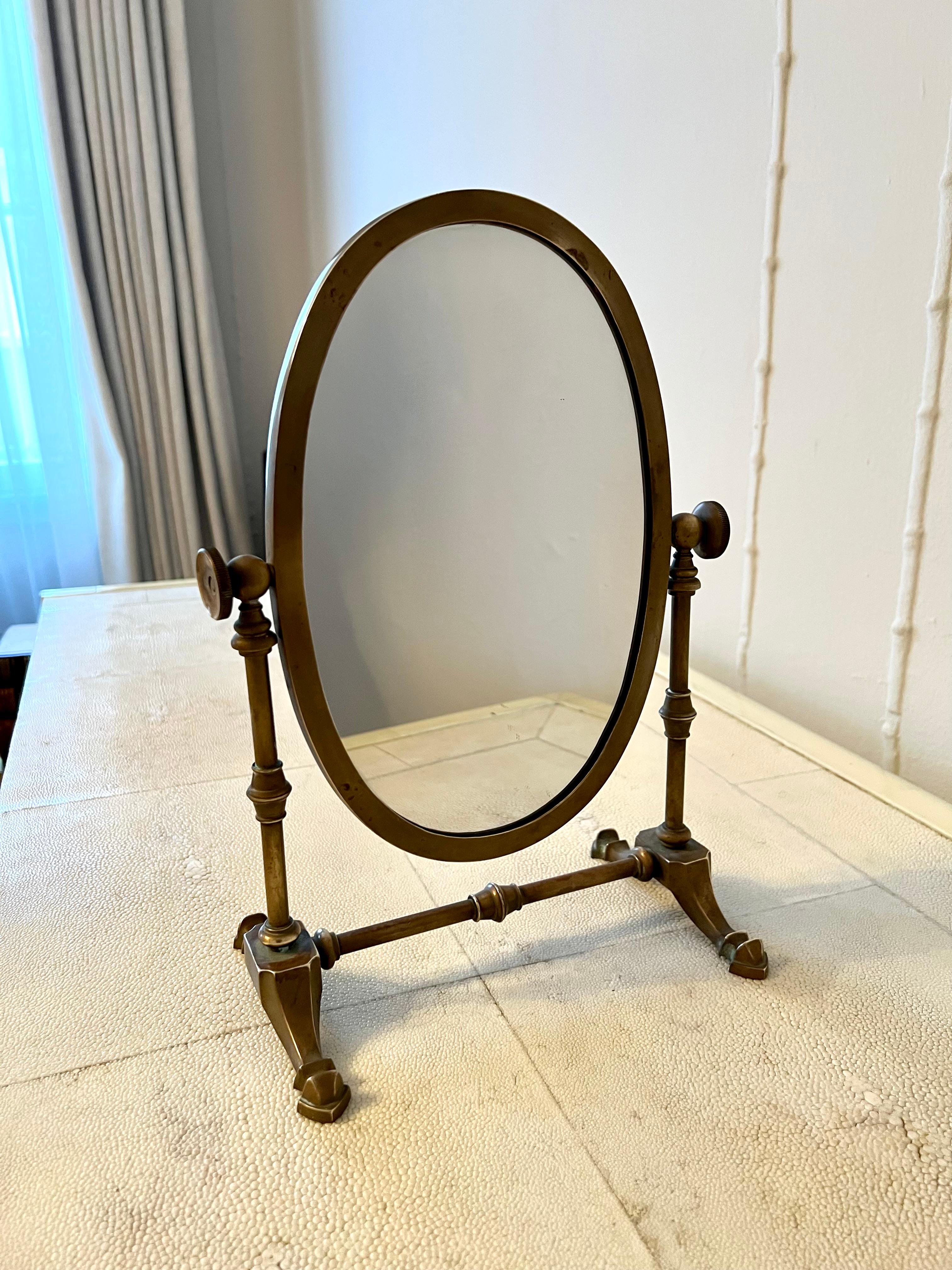 Vintage table or shaving mirror with charming patination. An oval mirror on the front, a felted back. Catches light beautifully on any table, particularly suited for the vanity or atop the dresser. A compliment to the vanity, dressing area.

Or