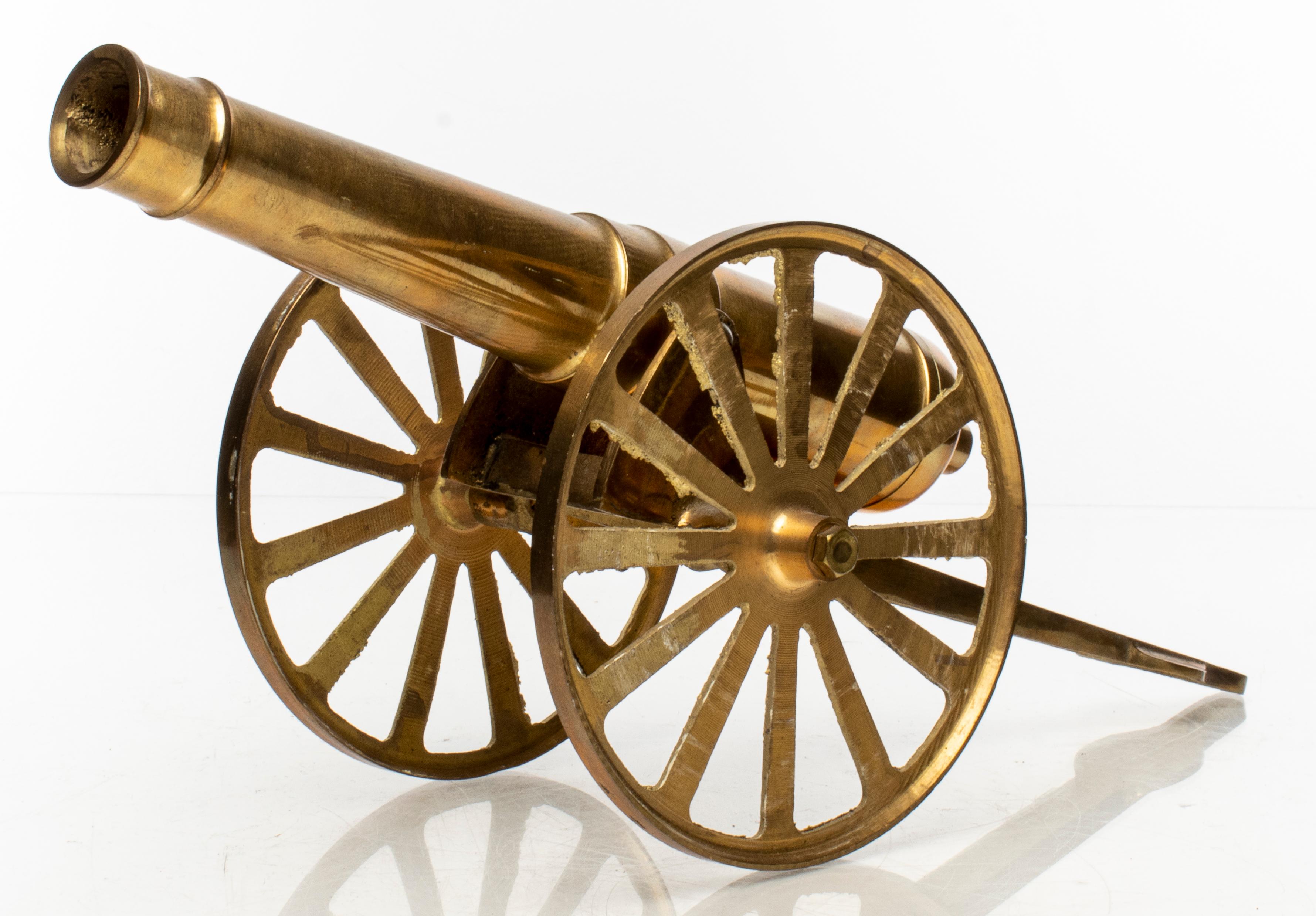 Brass tabletop model / sculpture of a cannon with articulated barrel. Measures: 7.5