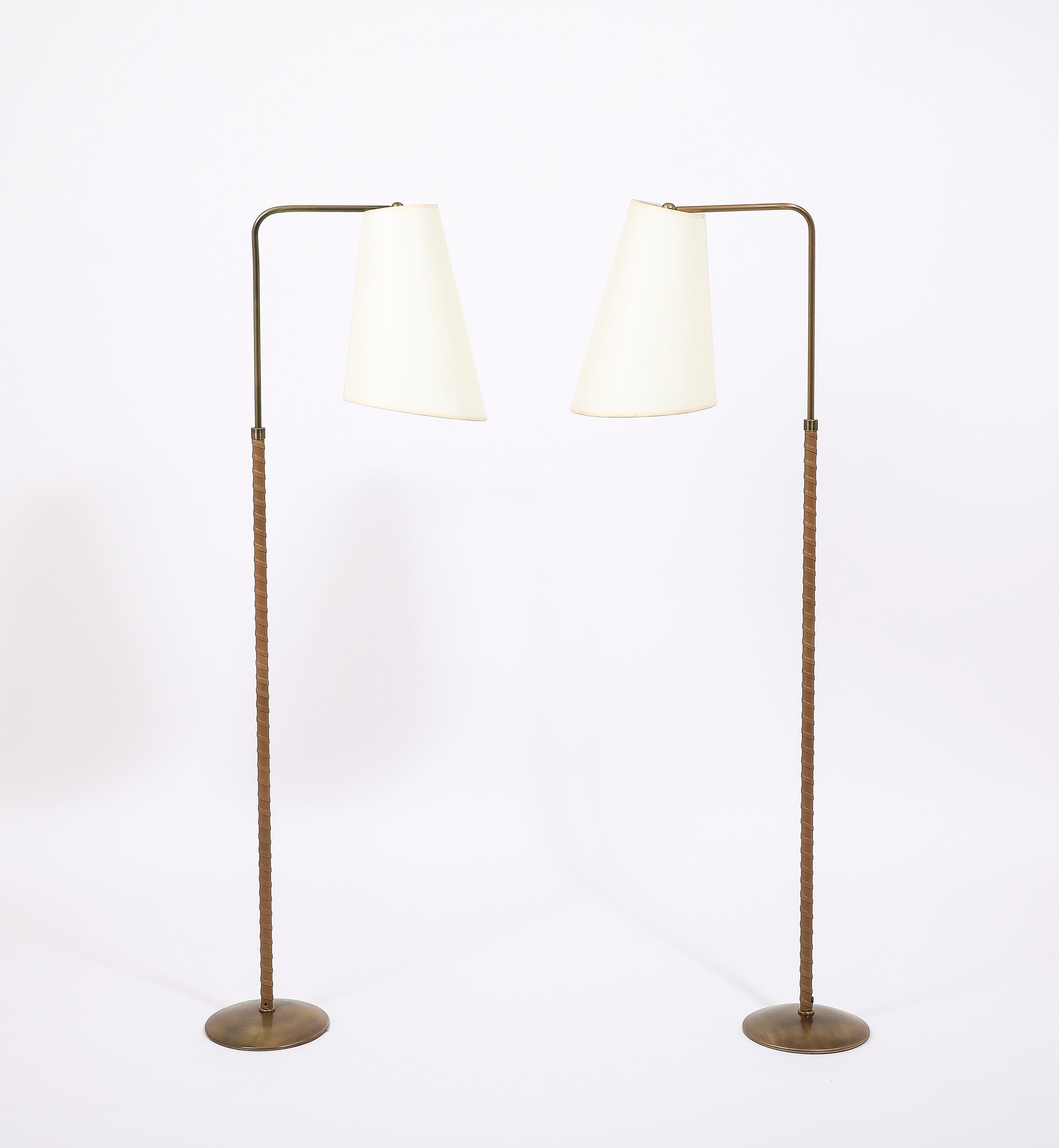 Brass reading floor lamps by Metalarte Elegantly Wrapped in a light tan leather, fully adjustable in height from 50” to 70”.
