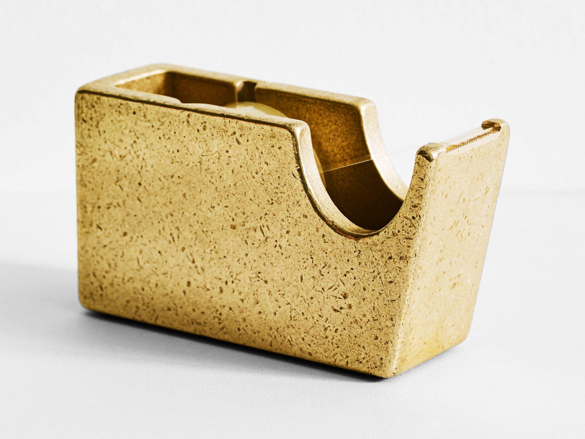 Brass Tape Dispenser by Henry Wilson
Dimensions: W 14 x D 5 x H 7 cm
Materials: Brass 

The brass tape dispenser is a hefty piece of stationery. It is cast in solid brass with machined teeth. Fits standard scotch tape rolls. It is rumble finished