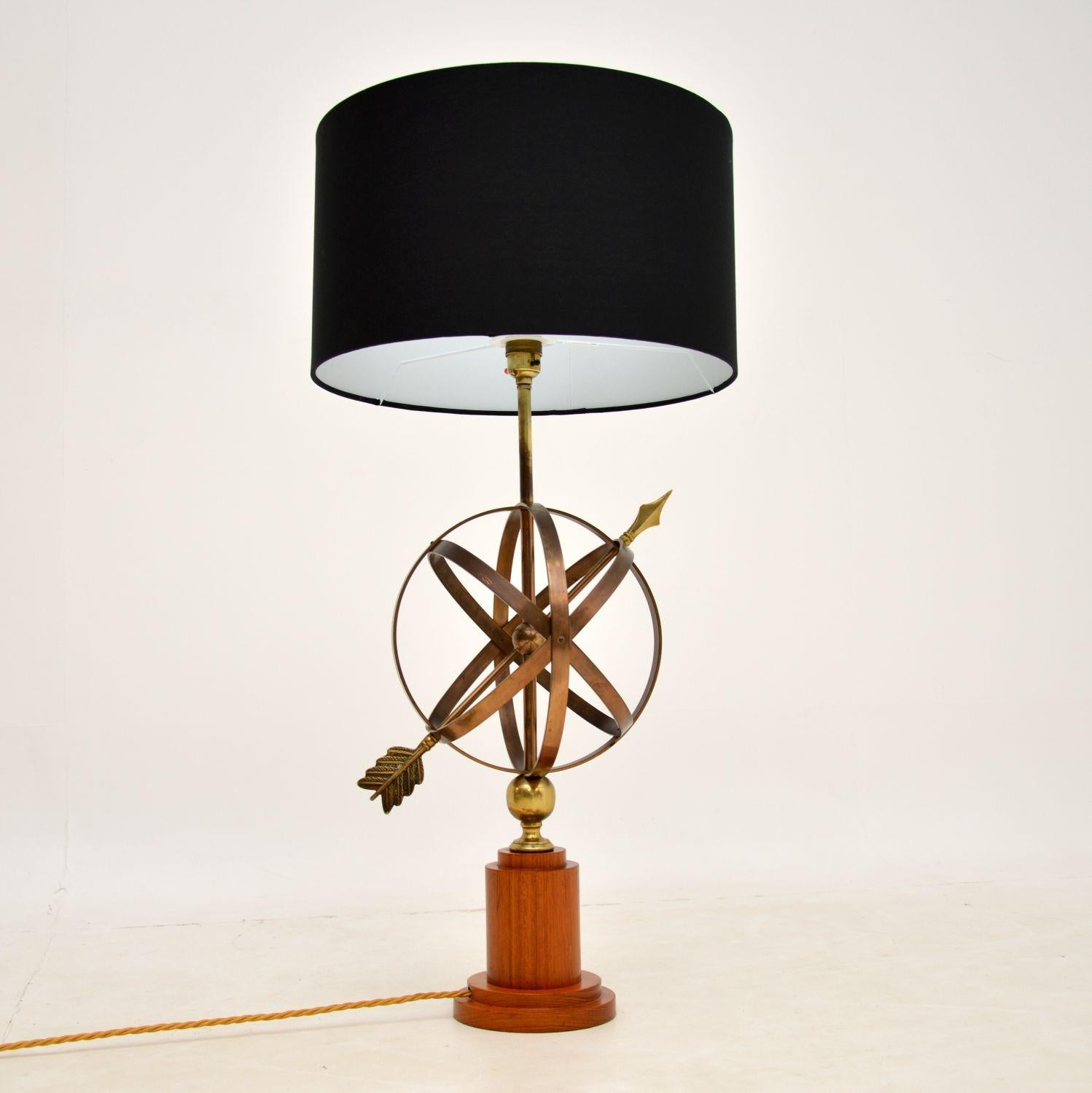 A stunning vintage brass armillary sphere table lamp, mounted on a solid teak base. This was made in England, it dates from the 1950-60’s.

An armillary sphere is an old astronomical instrument and model of the celestial globe, constructed from