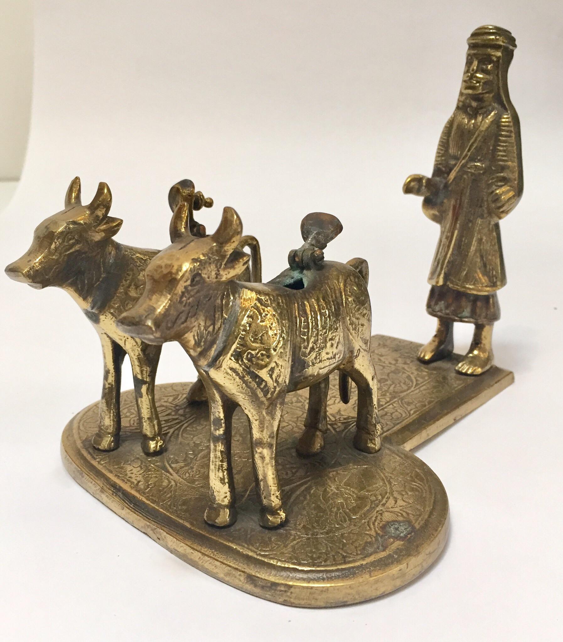 Handcrafted cast brass sculpture of cows and a holy man on stand.
Cows are considered holy in India.
Lord Shiva and Ma Parvati used to sit on Nandi and travel all-over the world and universe according to Hindu Vedas. If you visit a Shiv temple any