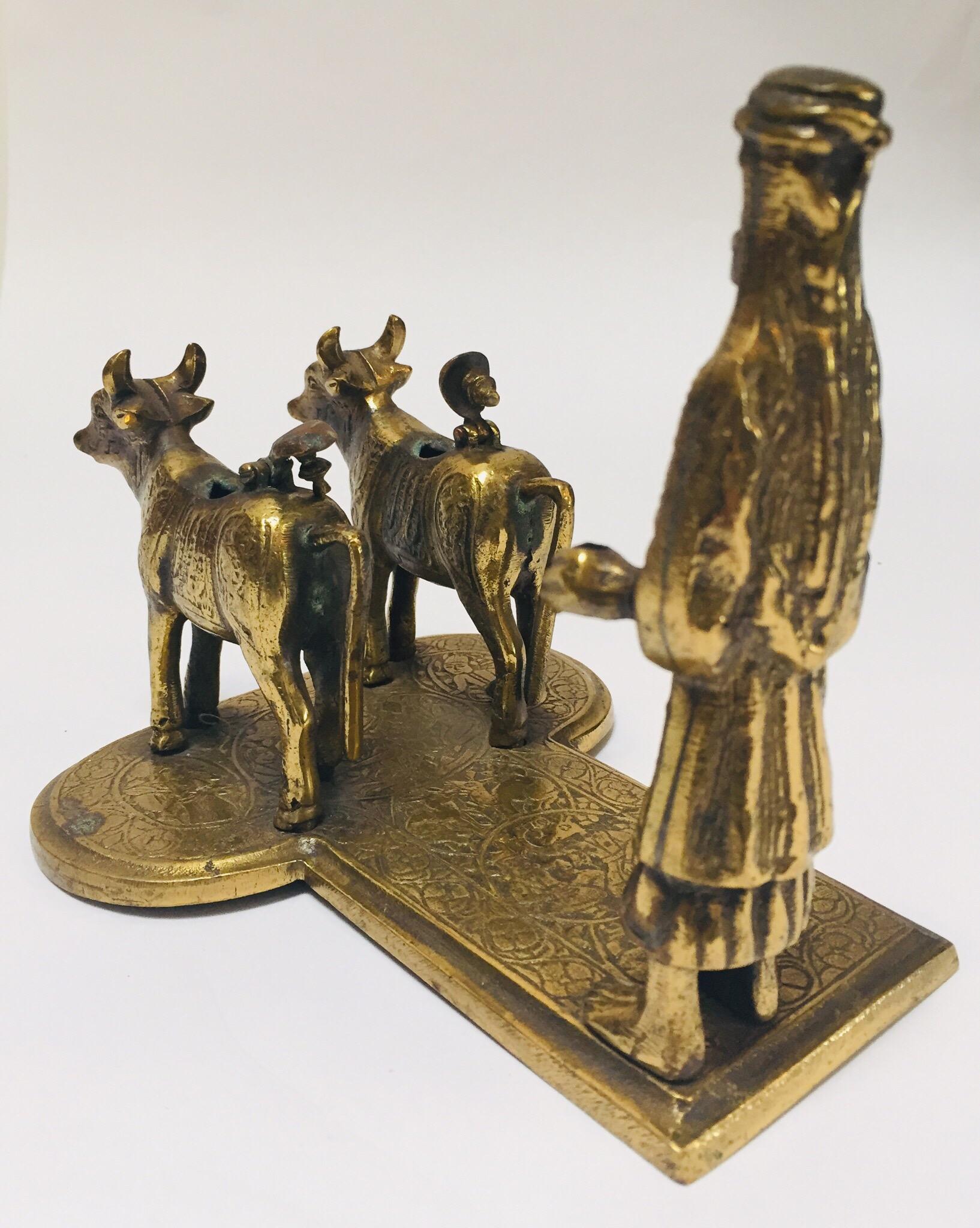 20th Century Brass Hindu Temple Oil Lamps Figures a Two Cows and Holly Man Standing For Sale