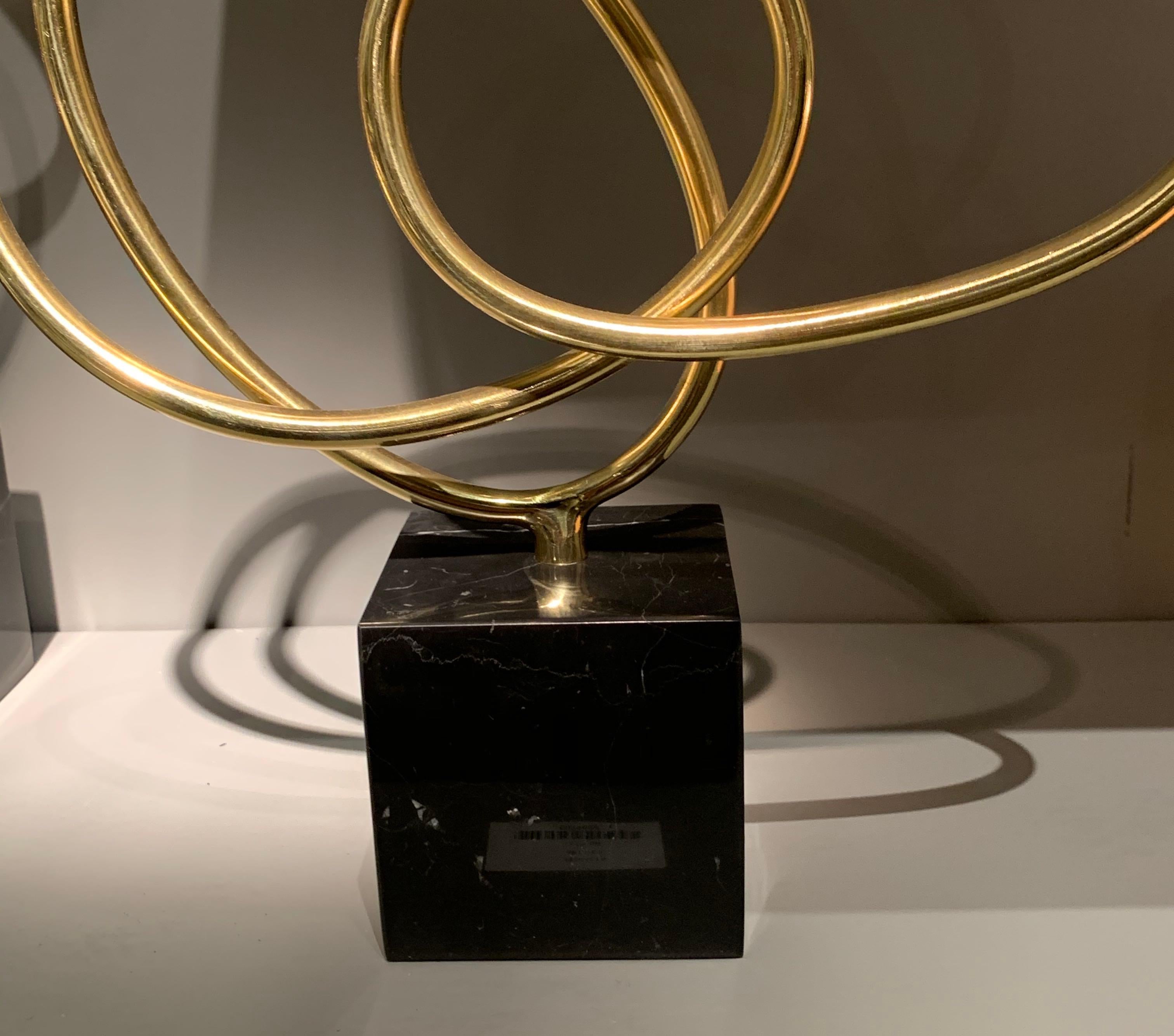 Thin ribbon shaped brass curves in a single piece to create a free form design.
The sculpture is mounted on black marble base.
Two other shapes / designs are also available (S5485, S5487).
The base measures 3.5