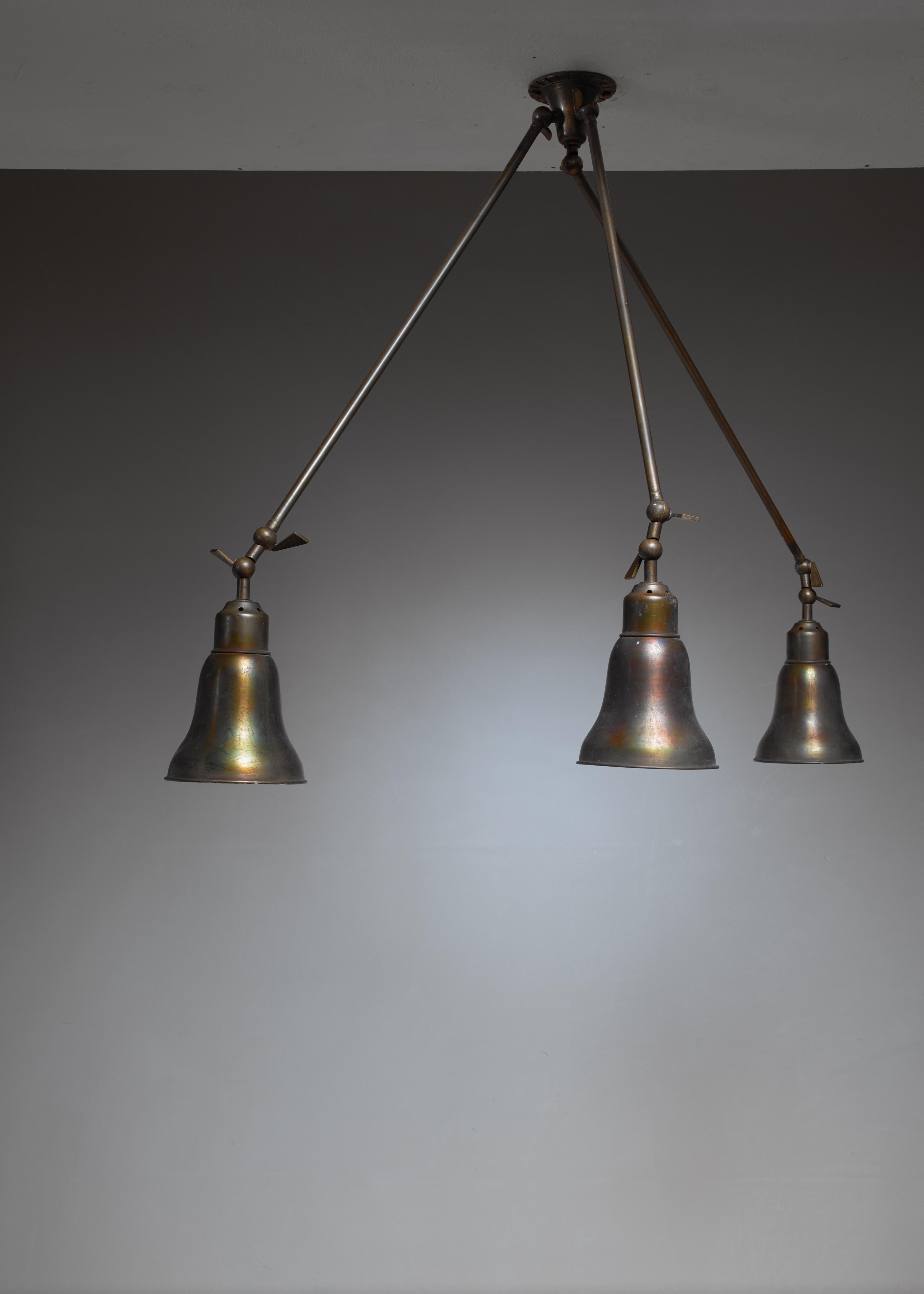 An Italian brass ceiling or wall lamp with three arms extending from the mount. Both the arms and shades are adjustable at three points. The shades have a 15 cm diameter.

The brass is beautifully darkened from age.