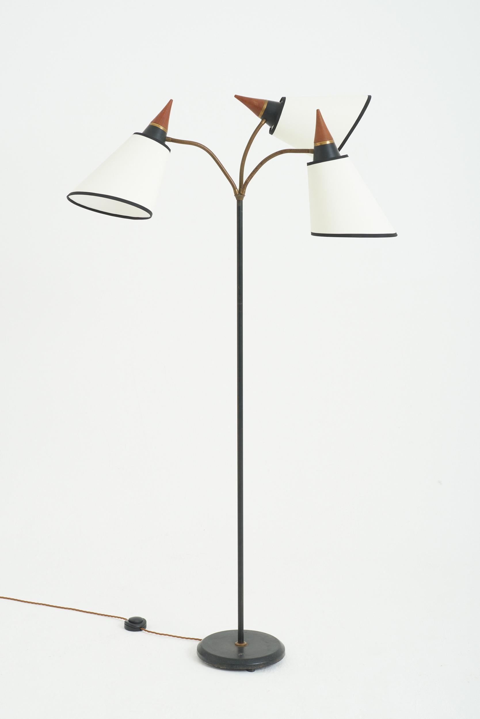 A black, brass and teak three-armed reading floor lamp.
Sweden, mid 20th Century
179 cm high by 90 cm wide by 90 cm depth