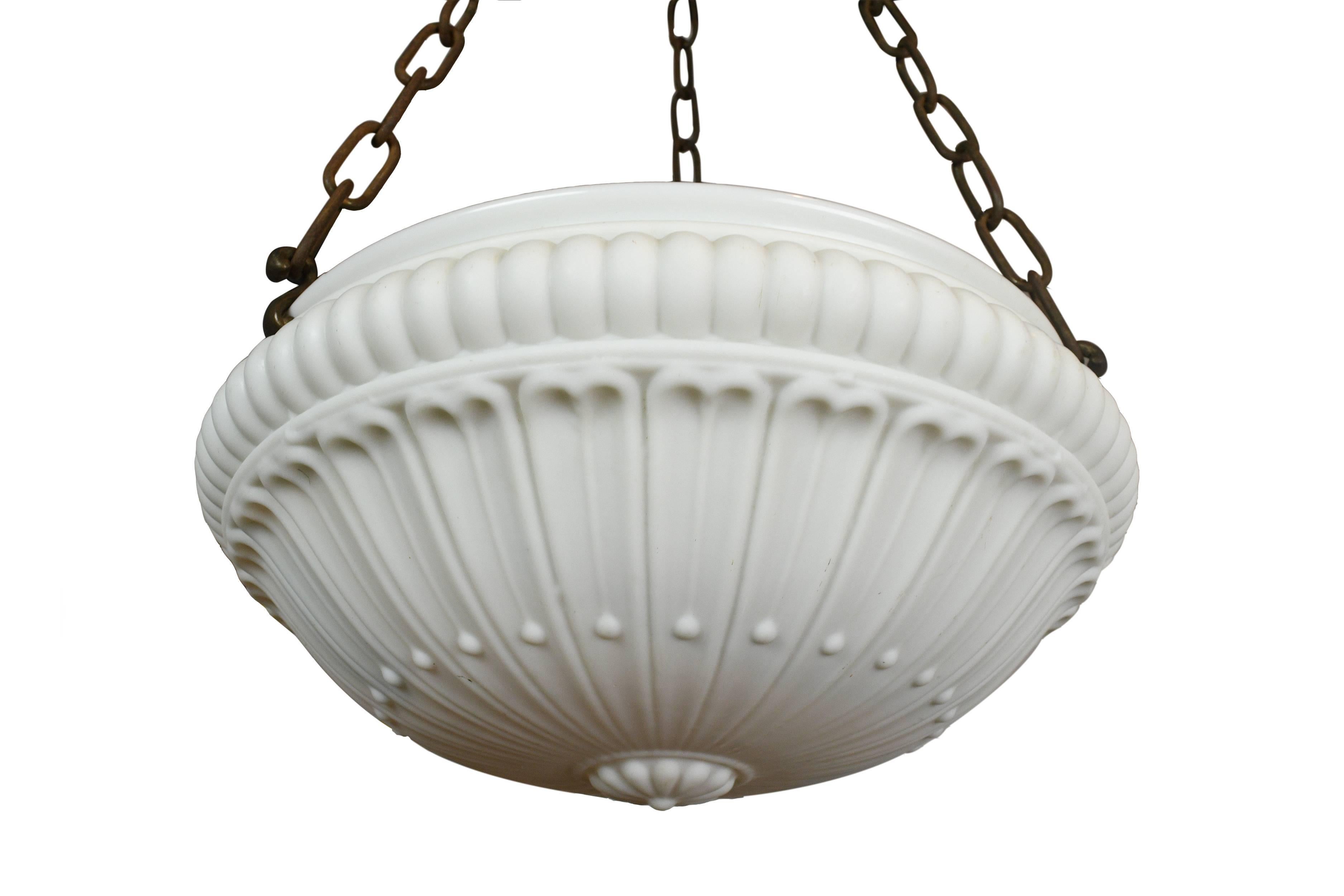 This is a very beautiful glass bowl chandelier. The glass is a milky white color with simple floral shapes on the surface. The pattern on the shade is soft and subtle. There are three sockets built in to the shade, which will help providing ample