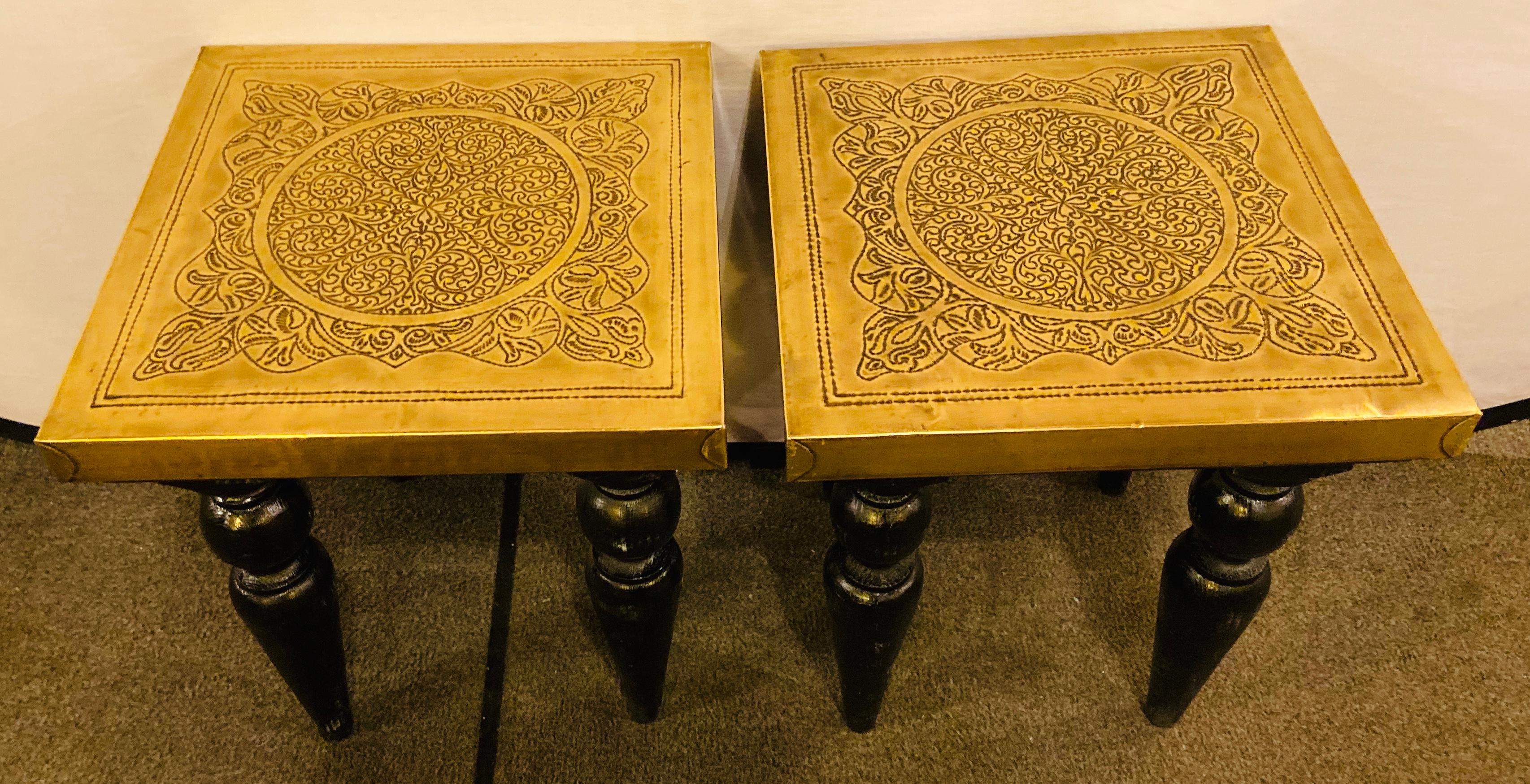 A chic pair of Hollywood Regency style square shaped end or side tables. The one of a kind tables are finely handmade of quality gold brass and wood. Featuring  an intricate filigree style design on the top, the tables curvy legs are painted in