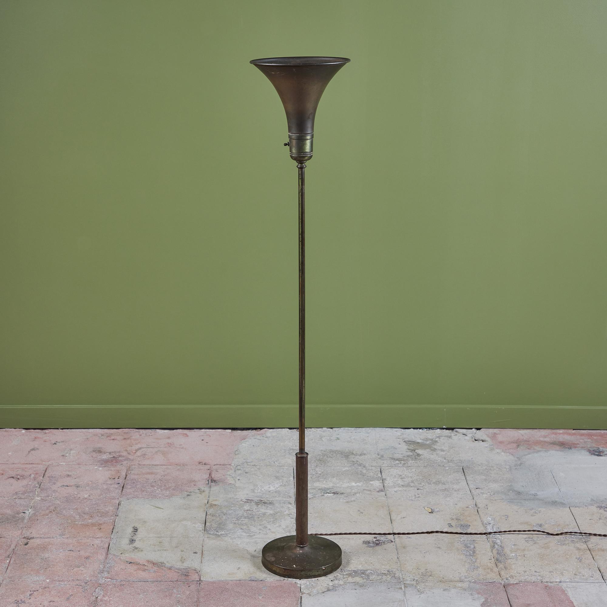 Perfectly patinated brass torchiere floor lamp features a tulip shade that directs light upwards and an on/off switch at the bottom of the shade.

Dimensions
11.75