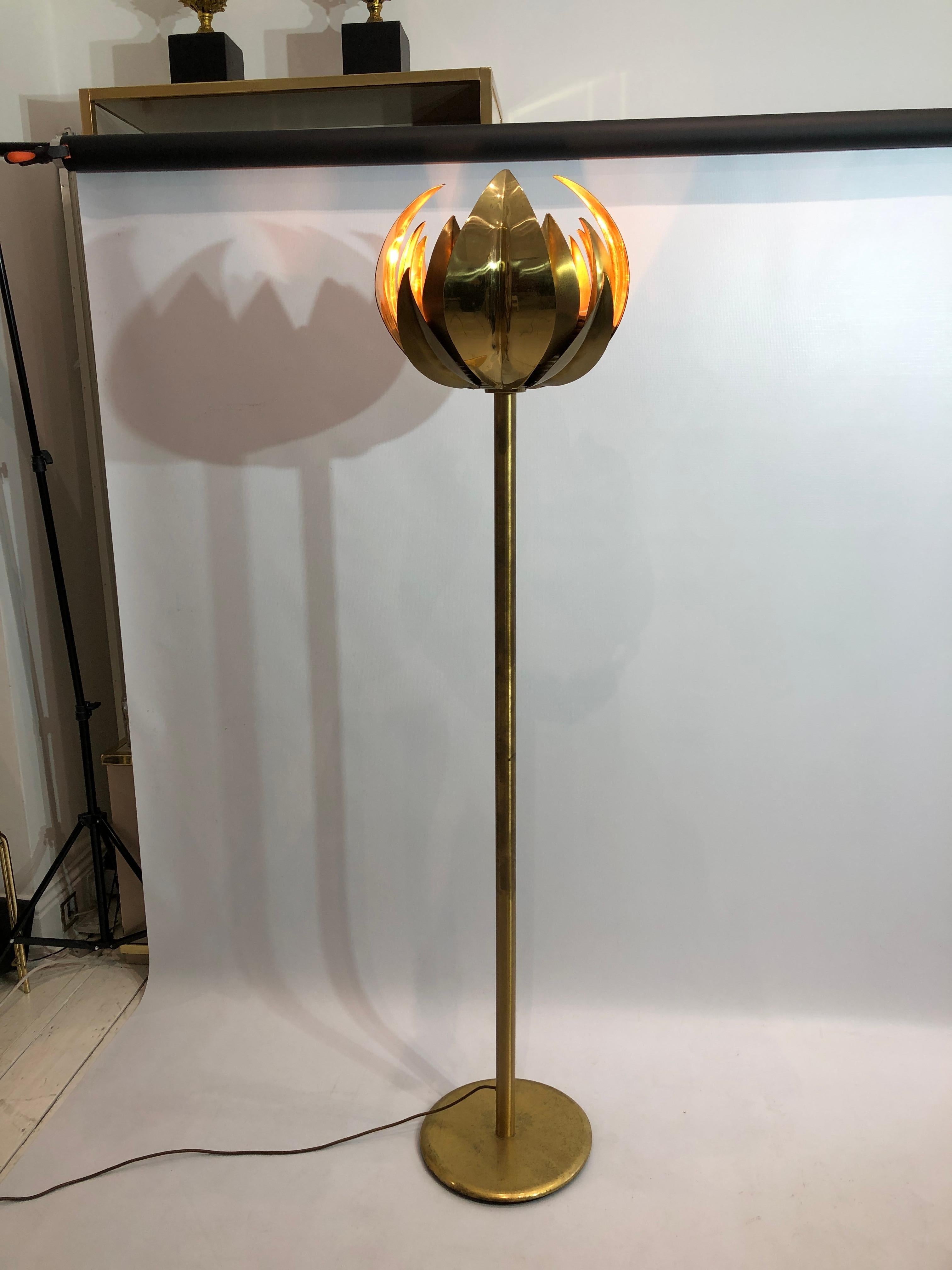 This extravagant brass torchiere floor lamp imported from Italy and is a stunning and highly rare example of design of Hollywood Regency opulence that previously attributed to Tommaso Barbi for Bottega Gadda. The base of the floor lamp is a circular