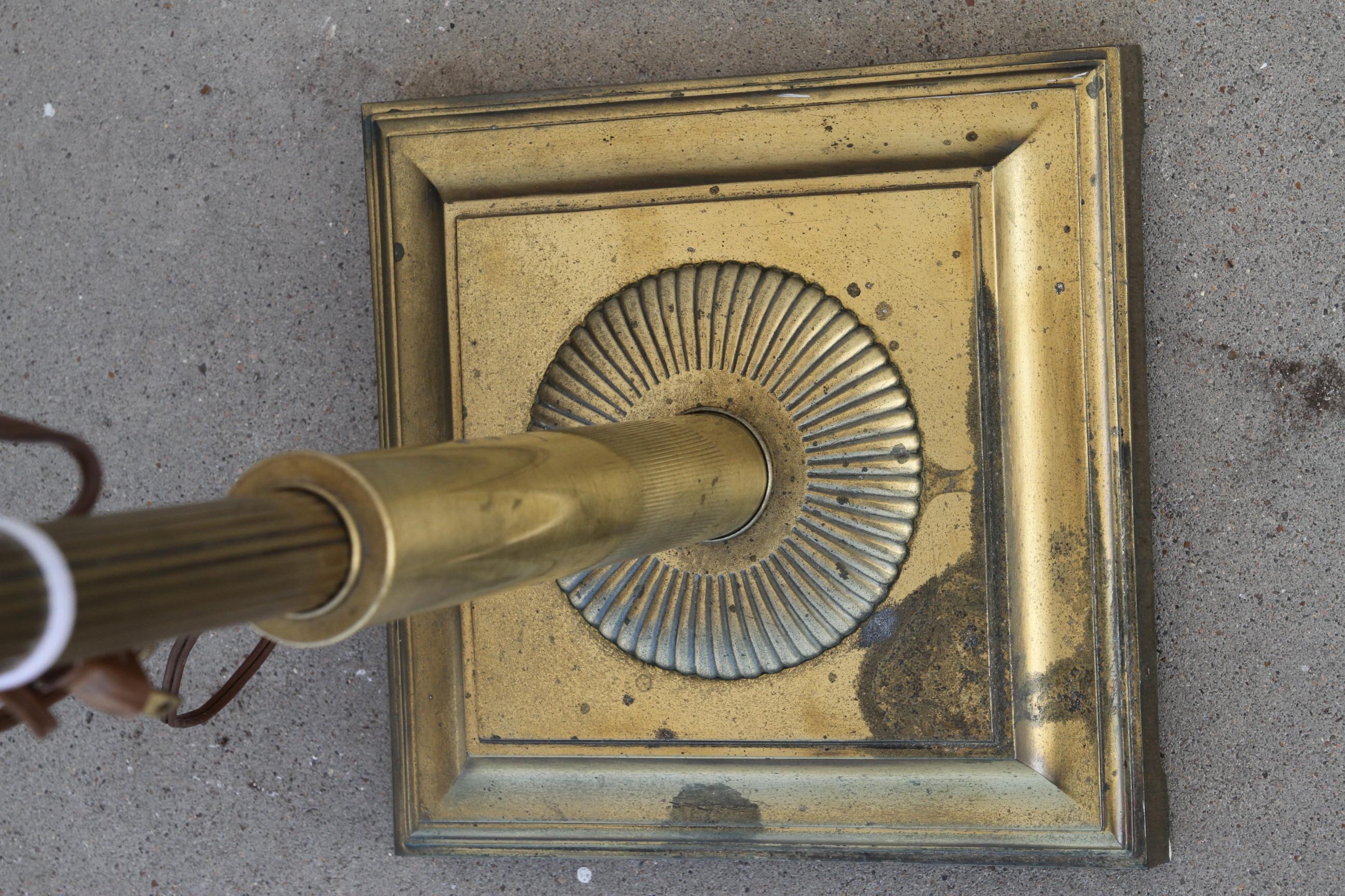 This is an early 20th century floor lamp.
It's constructed of brass and metal. It's base is weighted for stability. 

A good addition to any room.