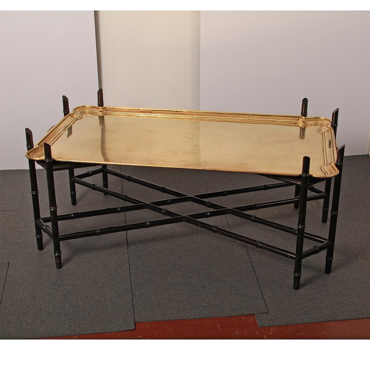 Brass tray top coffee table raised on a black lacquered faux bamboo eight-legged base with a double X form stretcher. The brass tray with two handles, Germany ca 1900.

Dimensions: 49
