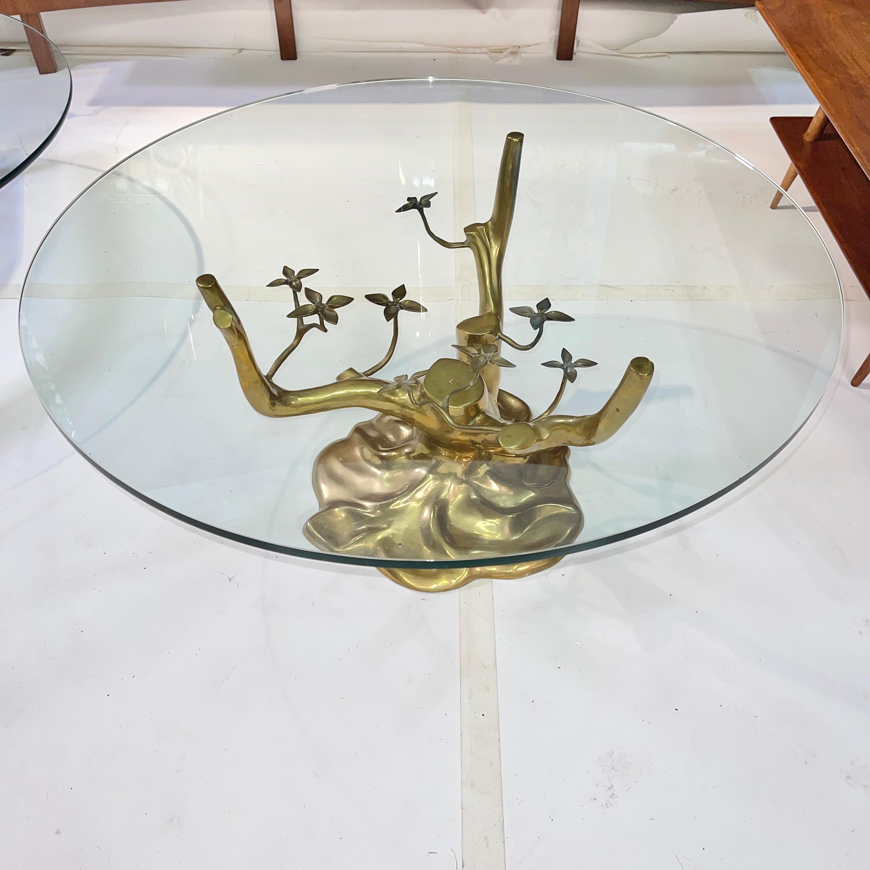 Sculpted and polished cast brass (bonsai) tree base table with three arms supporting a half inch thick round glass top 36 inches diameter.
Base alone is 17 inches high and 20 inches diameter.