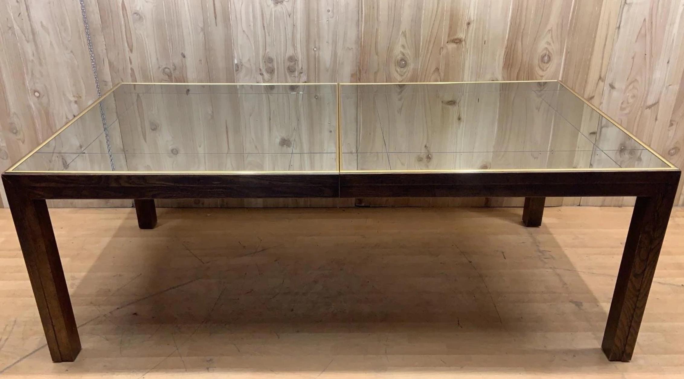 *** Shipping is NOT Free, please read below how to get a shipping quote. 

Vintage Mid Century Modern Brass Trim and Etched Smoked Mirror Extending Parsons Dining Table with 2 Leaves by Henredon

The Vintage Mid Century Modern Brass Trim and Etched