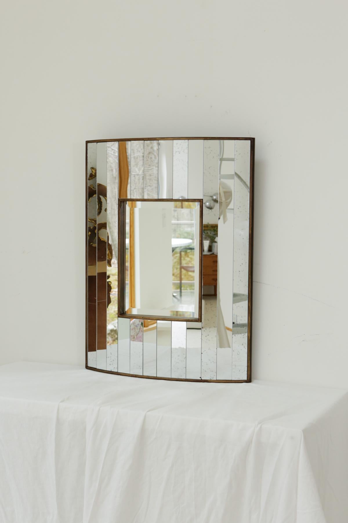 Perfect statement accent mirror that will match with any aesthetic! The backboard is thick wood and is bordered with brass trim. Sourced from a 17,000 sq ft mansion in Connecticut where it was decorated by a highly notable interior designer. In