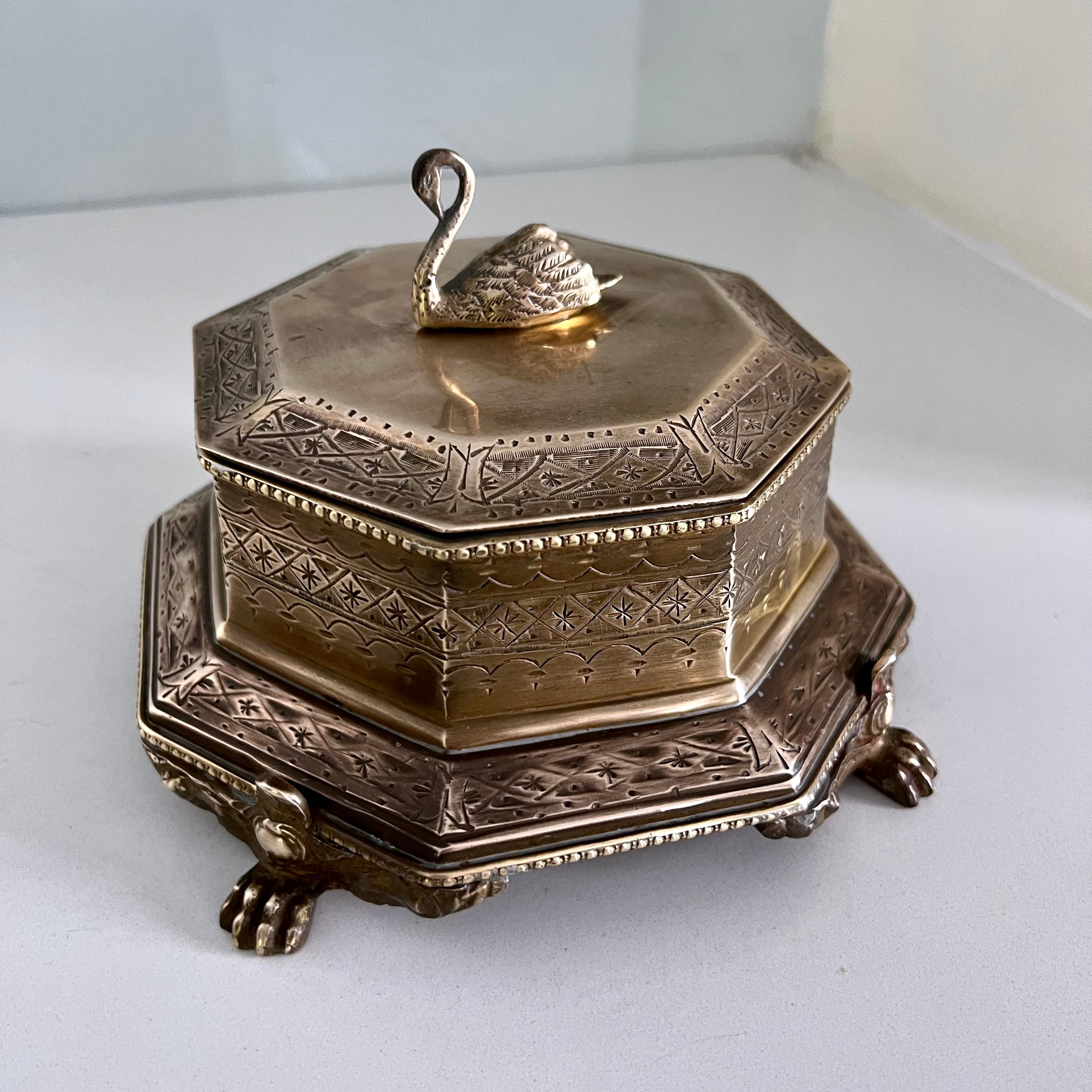 This gorgeous and commanding Brass Swan Finial Paw Feet Trinket Box has an octagon shape with ornate intaglio designs on the outside. A compliment to any table or vanity. Let this swan watch over your trinkets, mementos of 420. 

Paw feet give