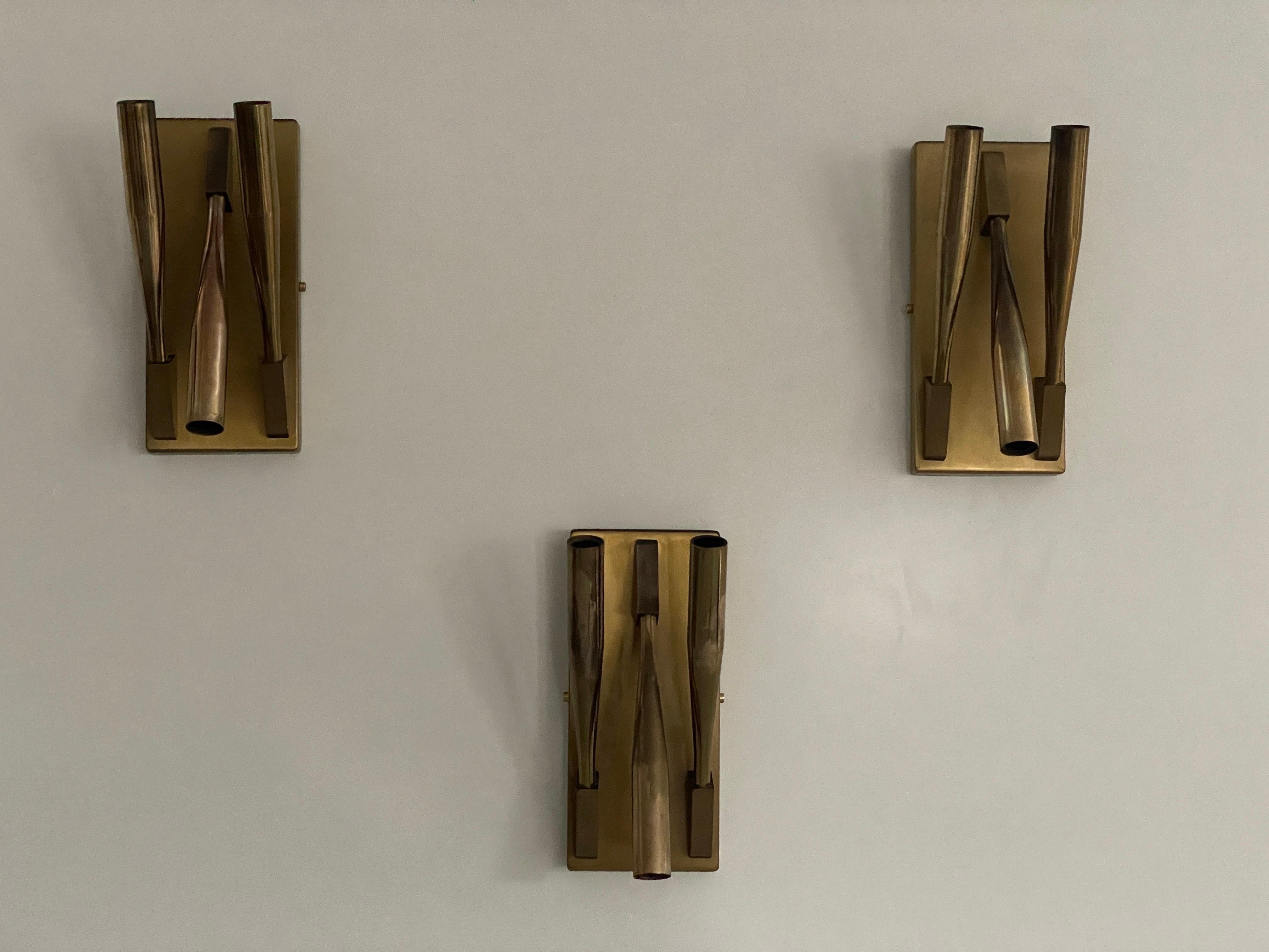 Brass Triple Tube Shade Set of 3 Sconces Attributed Gio Ponti, 1950s, Italy

Very elegant and Minimalist heavy wall lamps
Lamps are in very good condition.

These lamps works with 3x E14 standard light bulbs. 
Wired and suitable to use in all