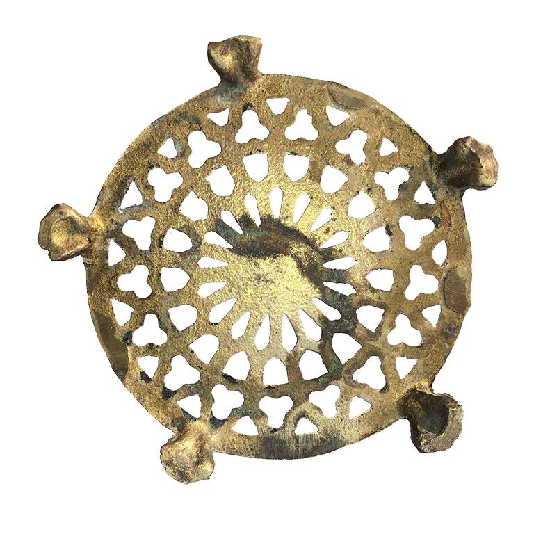 Brass quatrefoil trivet with clawfoot legs. A beautiful detail for any kitchen. Great for setting hot pots and pans and a great accent for the countertop or dining table while not in use.