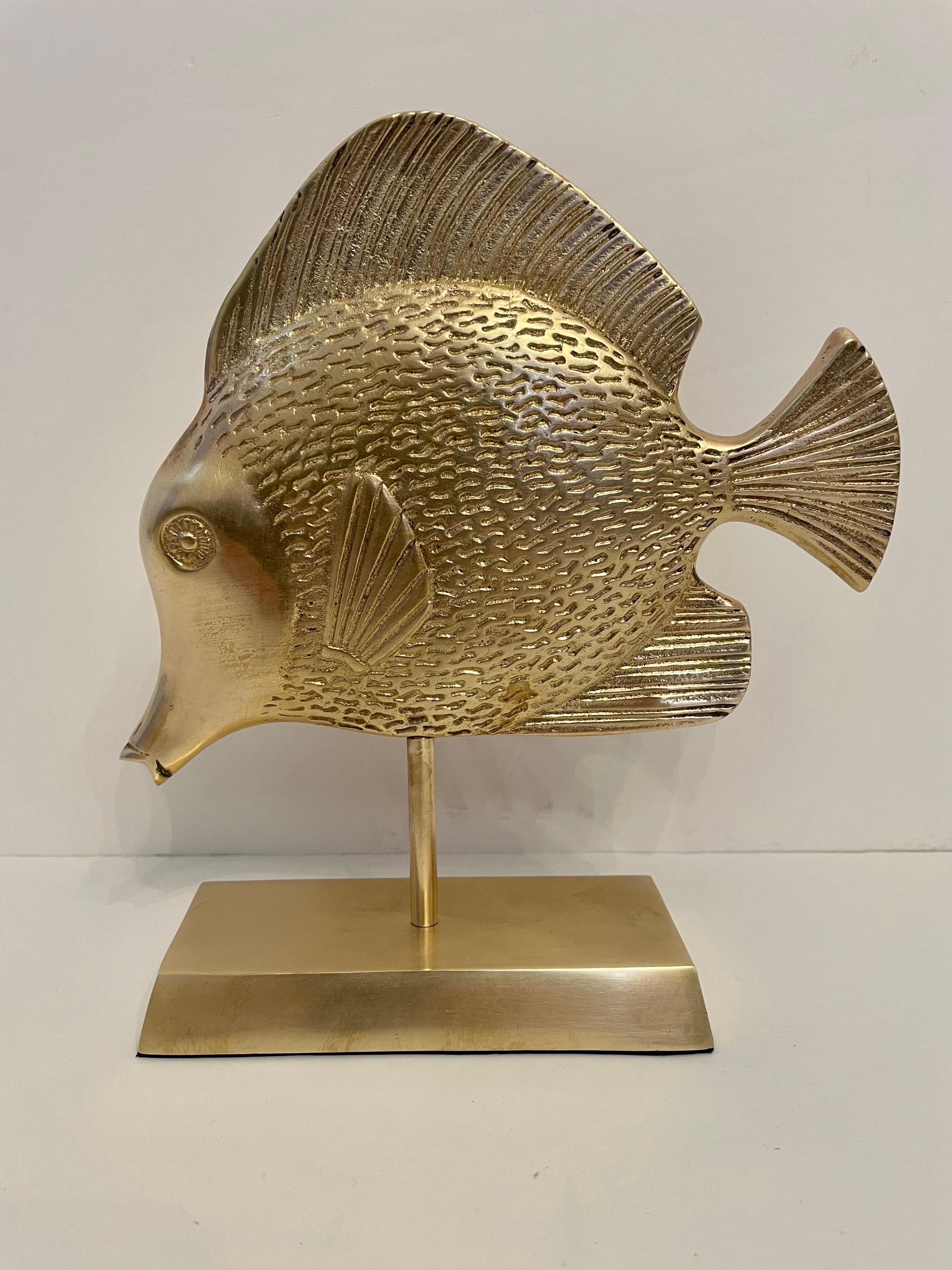 Brass Tropical tang fish sculpture on brass stand. Rubbery felt on bottom of base. Overall good condition. Dark and light spots in photos is reflection. Will look great on desk or bookcase.