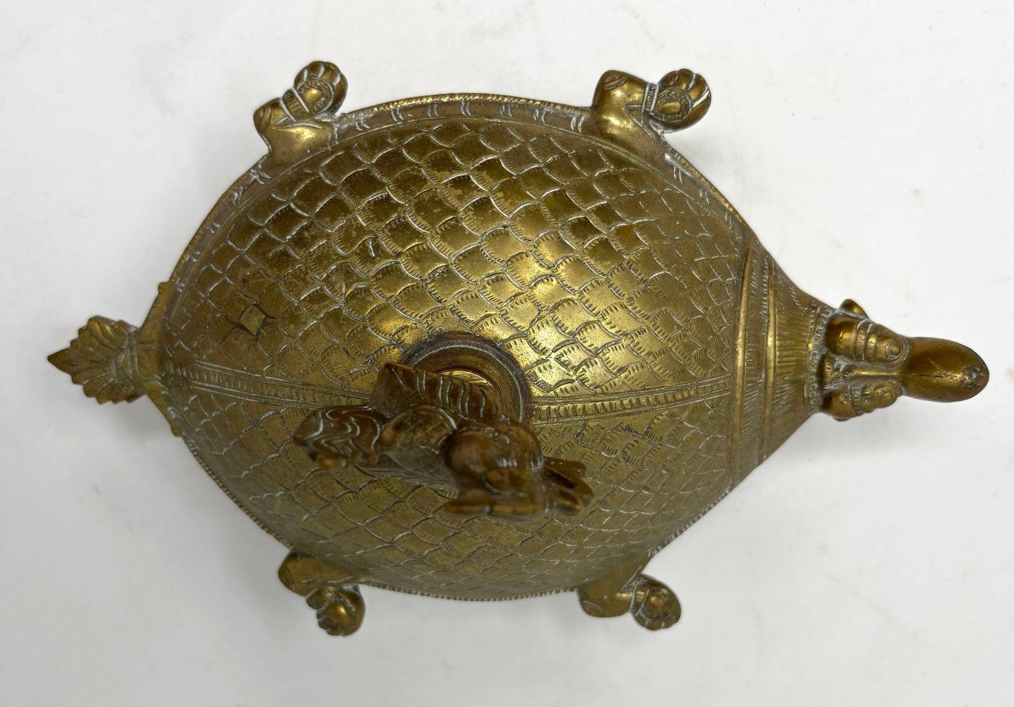 Vintage turtle metal brass box Box with bird finial on wheels.
The large heavy brass turtle shape with a beautiful patina metal box open to a large container to use as a trinket box, for incense, ring box, ashtray or just a decorative Asian metal