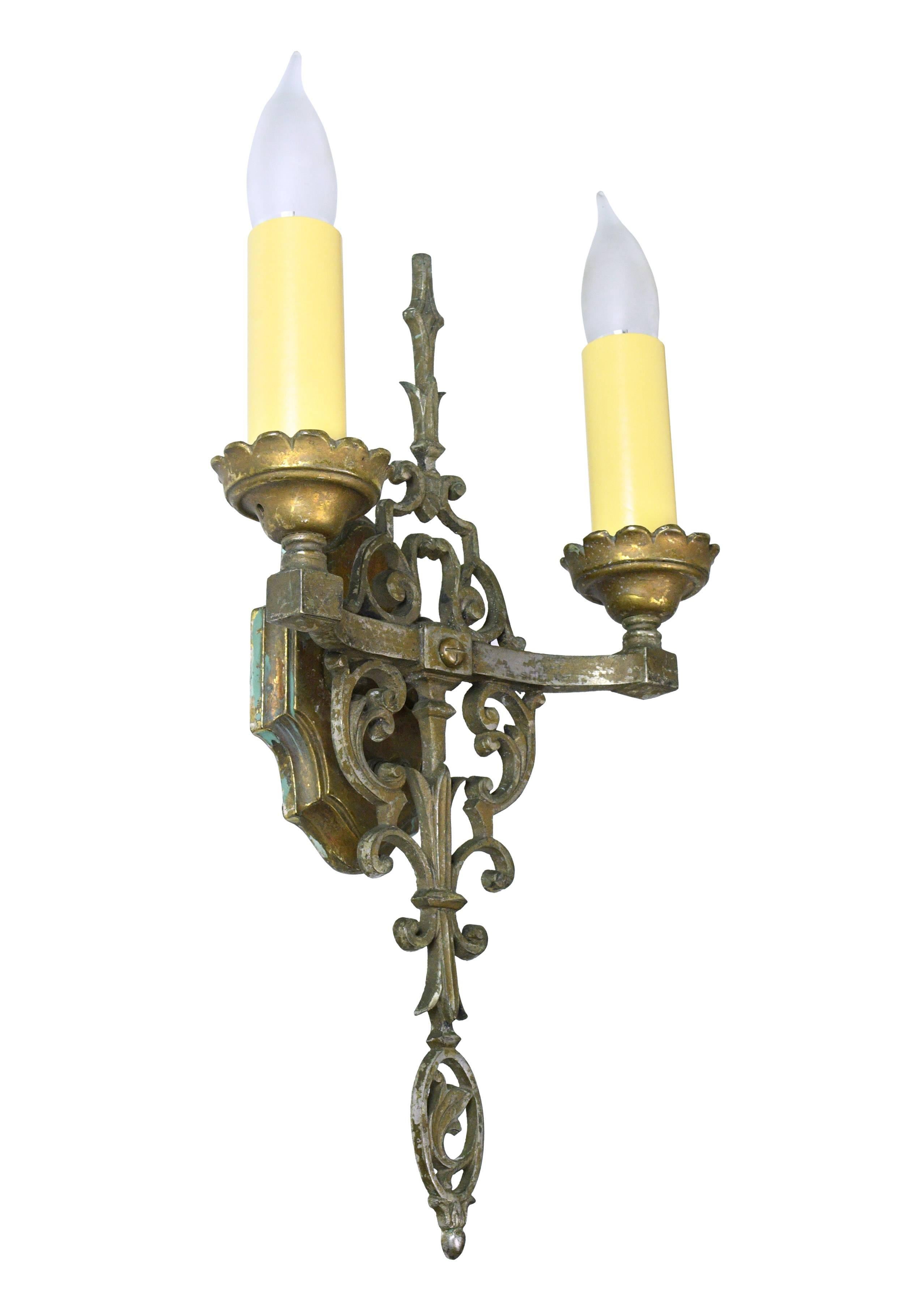 Elegant, tall cast brass Tudor sconce with delicate swirling motifs throughout. This fixture exudes an understated grace that will perfectly compliment any number of design styles, 

circa 1910
Condition: Excellent
Finish: Original
Country of