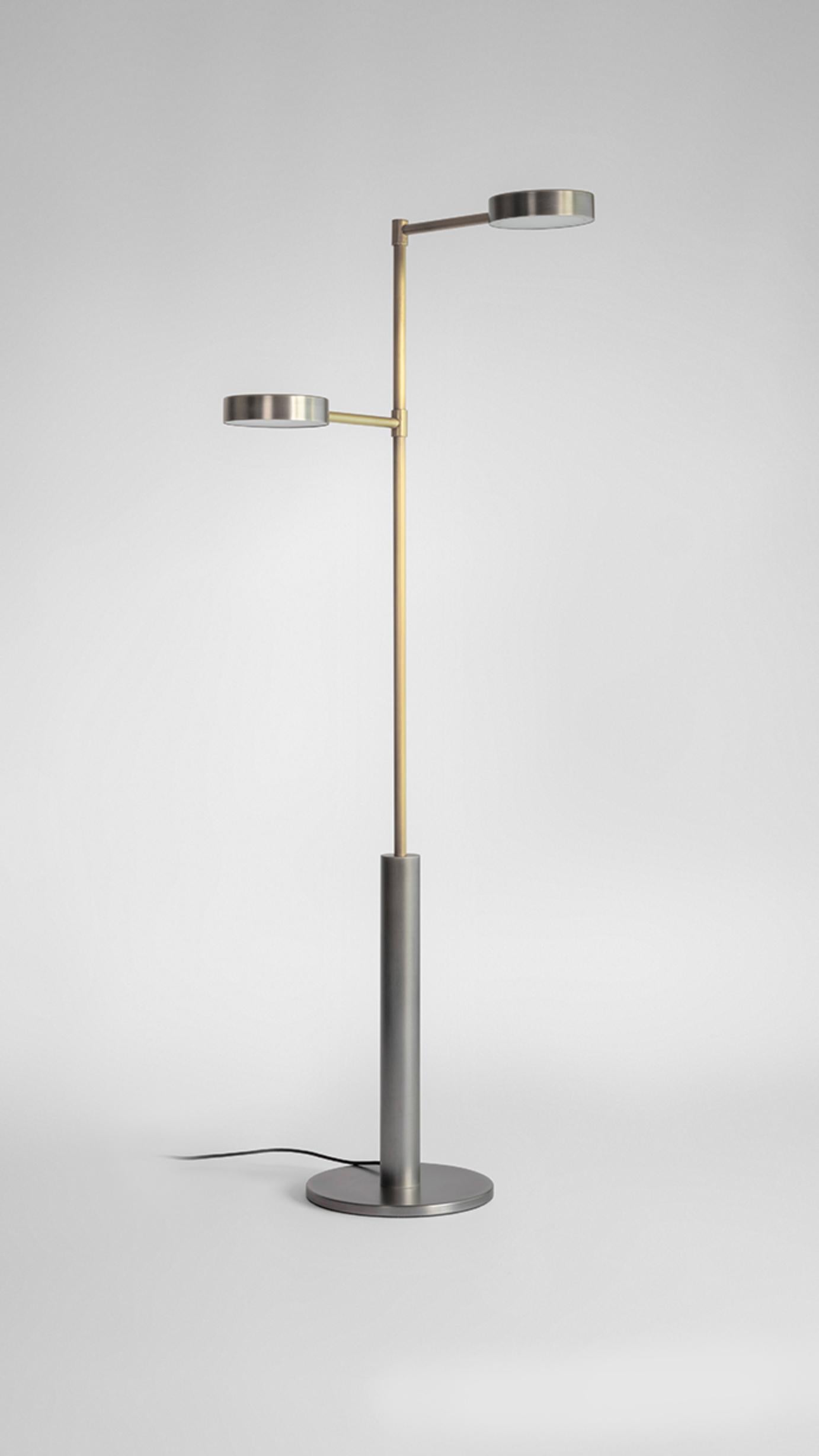 Brass Two Cylinders Floor Lamp by Square in Circle
Dimensions: H 145 x W 48 x D 28 cm
Materials: Brushed brass finish, white painted metal shades, brushed brass inner finish

This floor lamp is crafted from a brushed grey cylindrical base. It's two