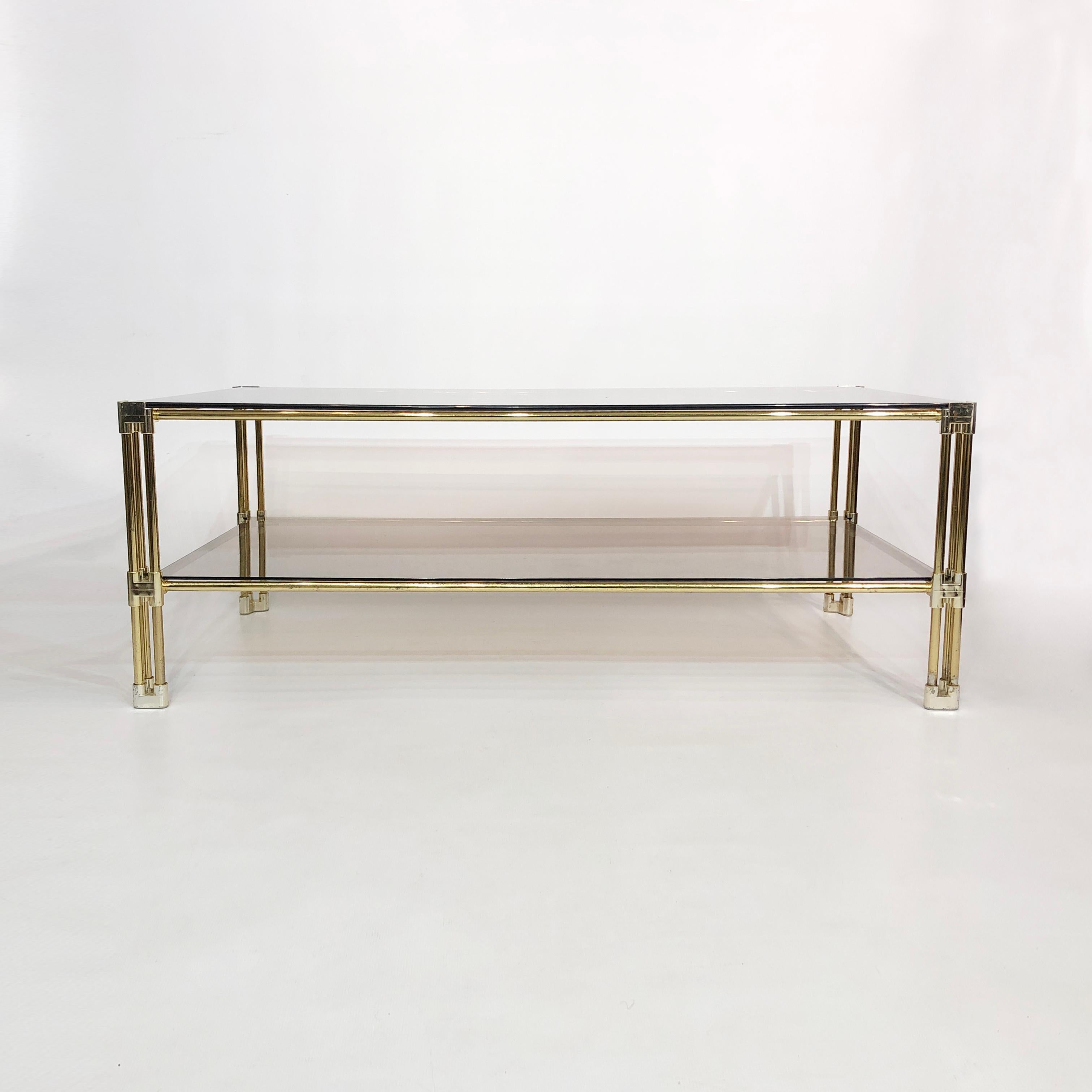 Late 20th Century Brass Two-Tiered Coffee Table Hollywood Regency Gold Smoked Glass 1970s Glamour For Sale