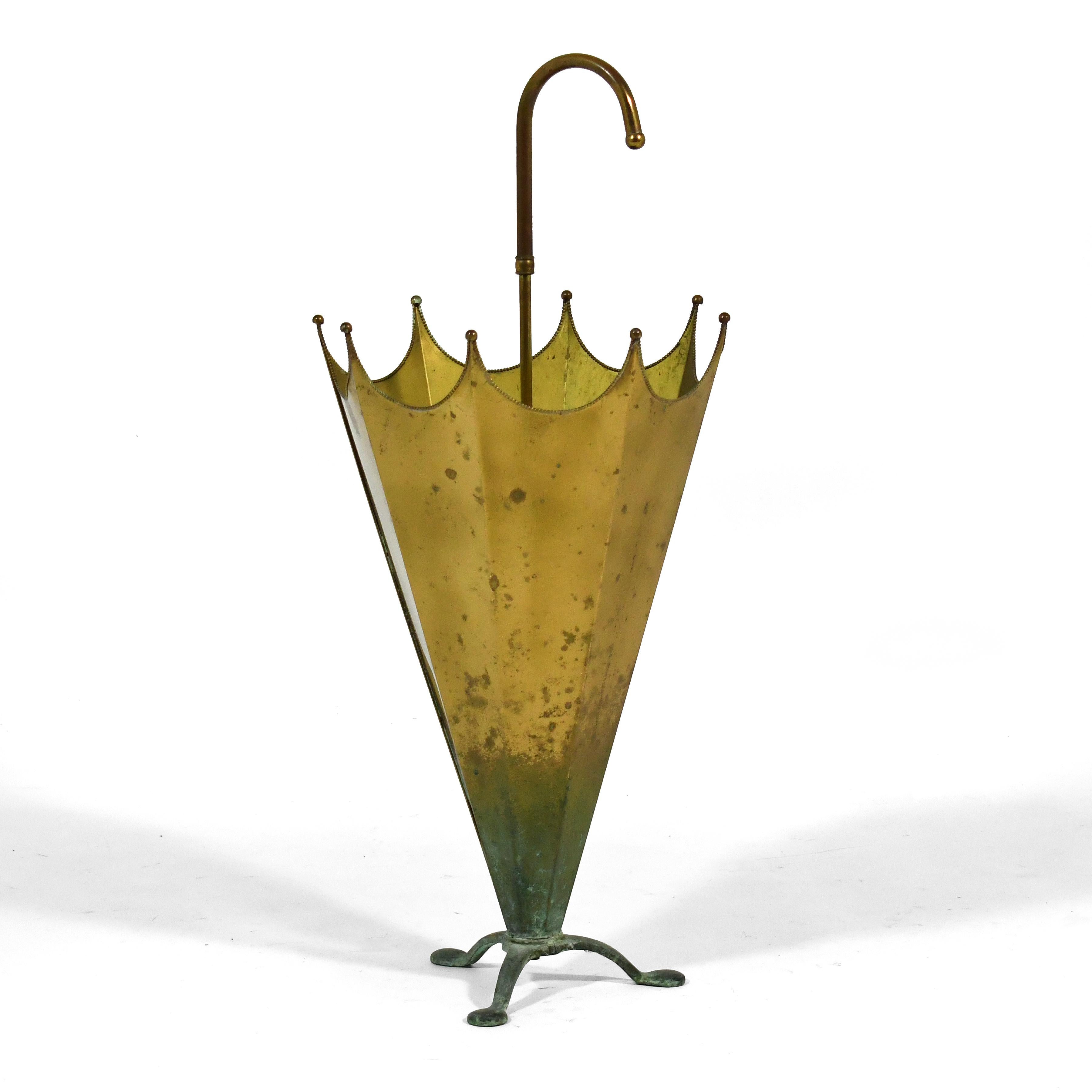 This lovely vintage brass umbrella stand is in the form of an umbrella. The rich patina is a testament to it's years of age and use.