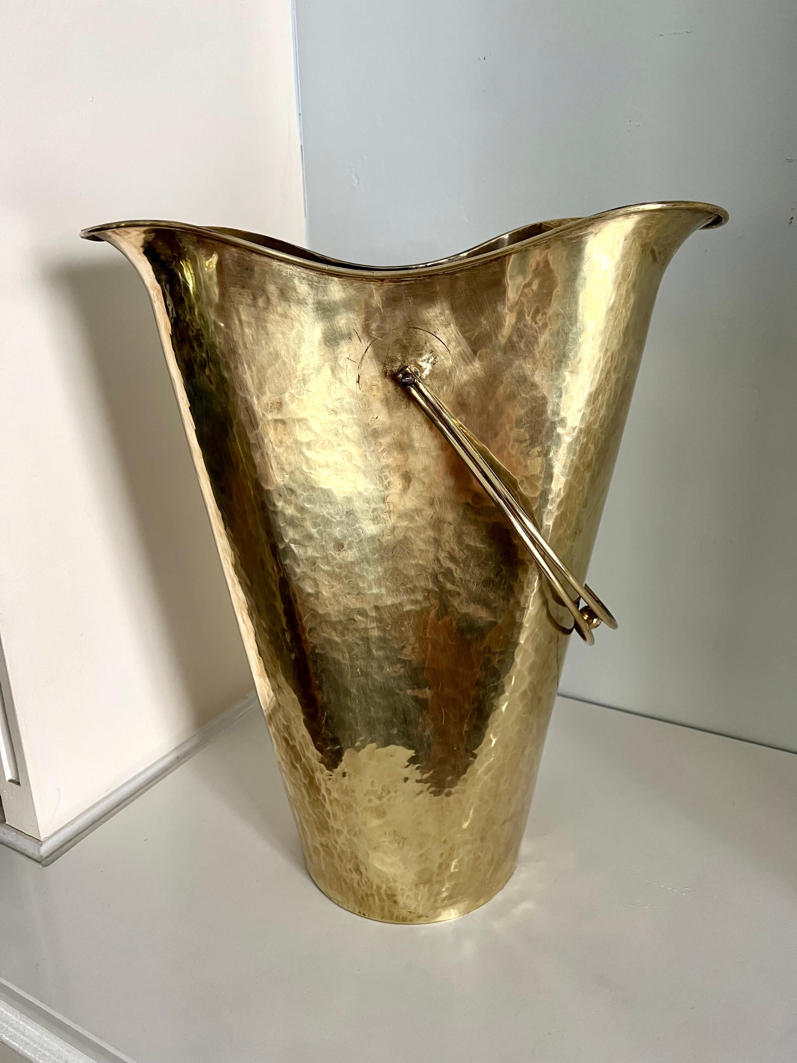 A unique brass container, could be used as an umbrella stand or as another option, as a kindling or wood container next to the fireplace. The size is large and will hold a lot of either umbrella's or kindling. ... Or be creative and use the
