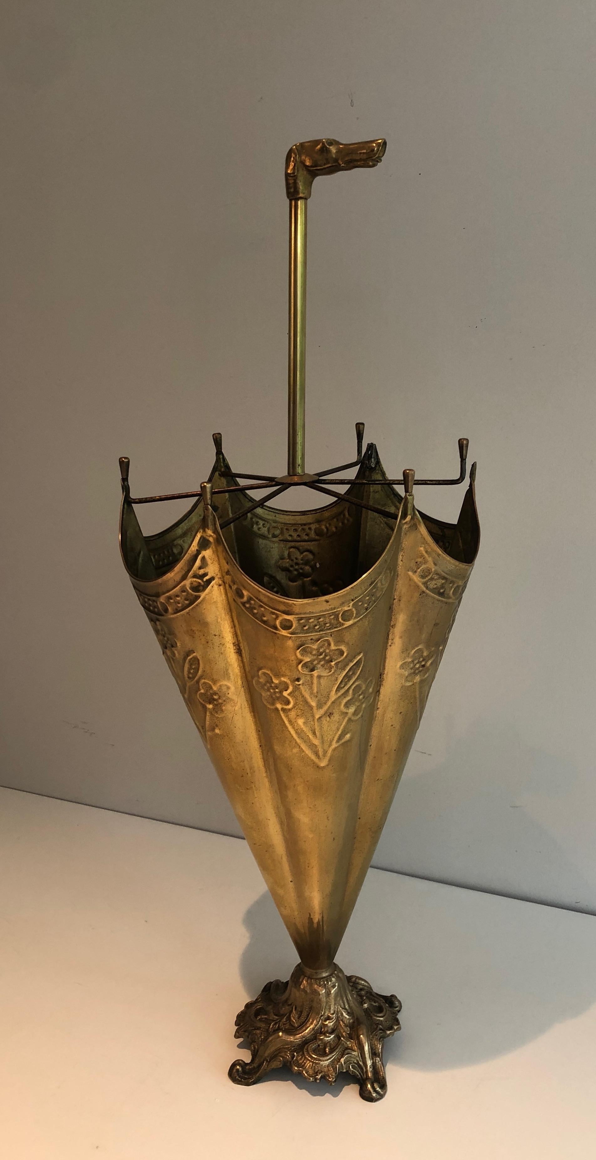 This nice and unusual umbrella stand is made of a embossed brass with an handle representing a bronze dog's head. This is a French work. Circa 1940