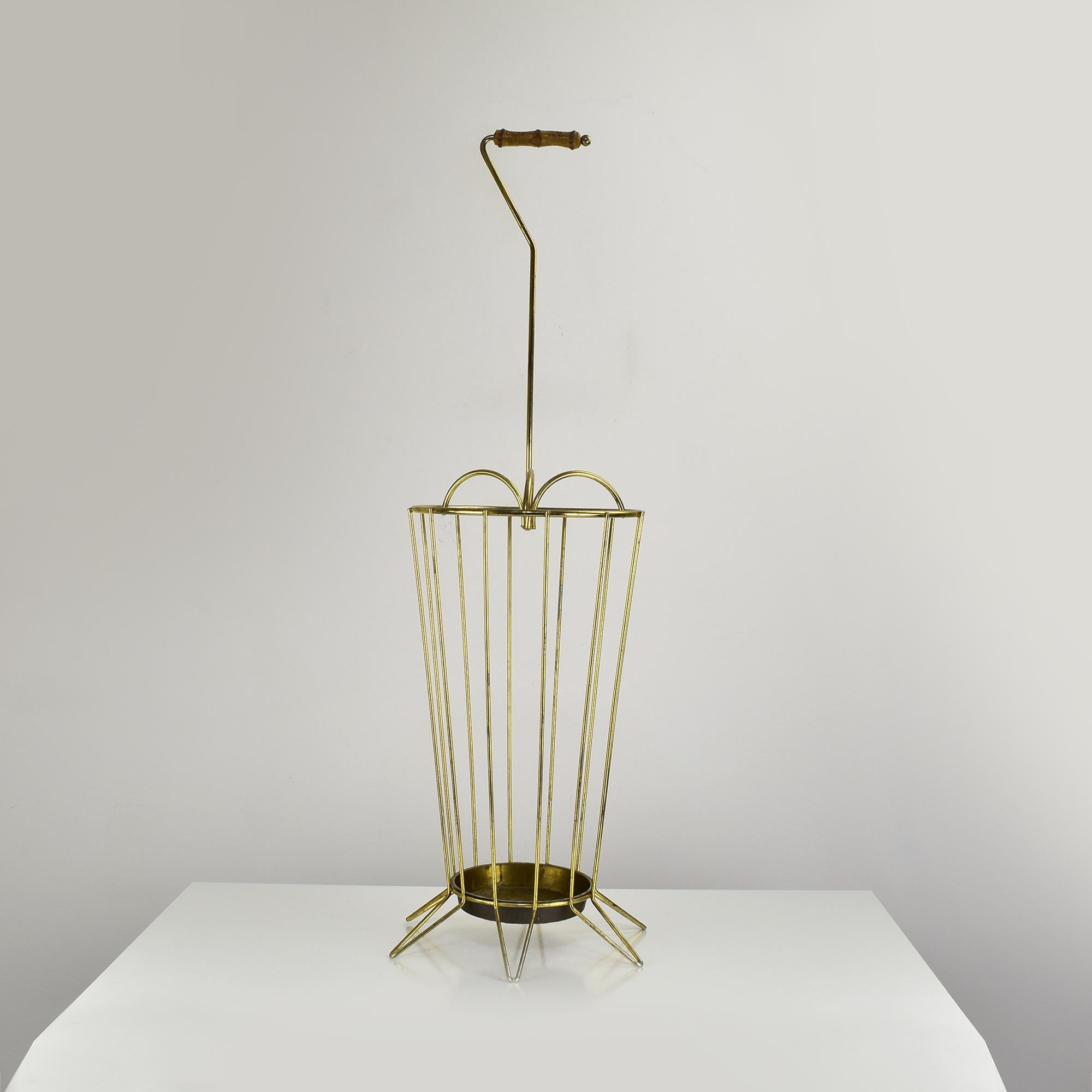 This vintage brass umbrella stand exudes Mid-Century Modern elegance with its openwork wireframe structure and sophisticated bamboo handle. Likely originating from Vienna, this piece embodies both function and style, making it a perfect addition to
