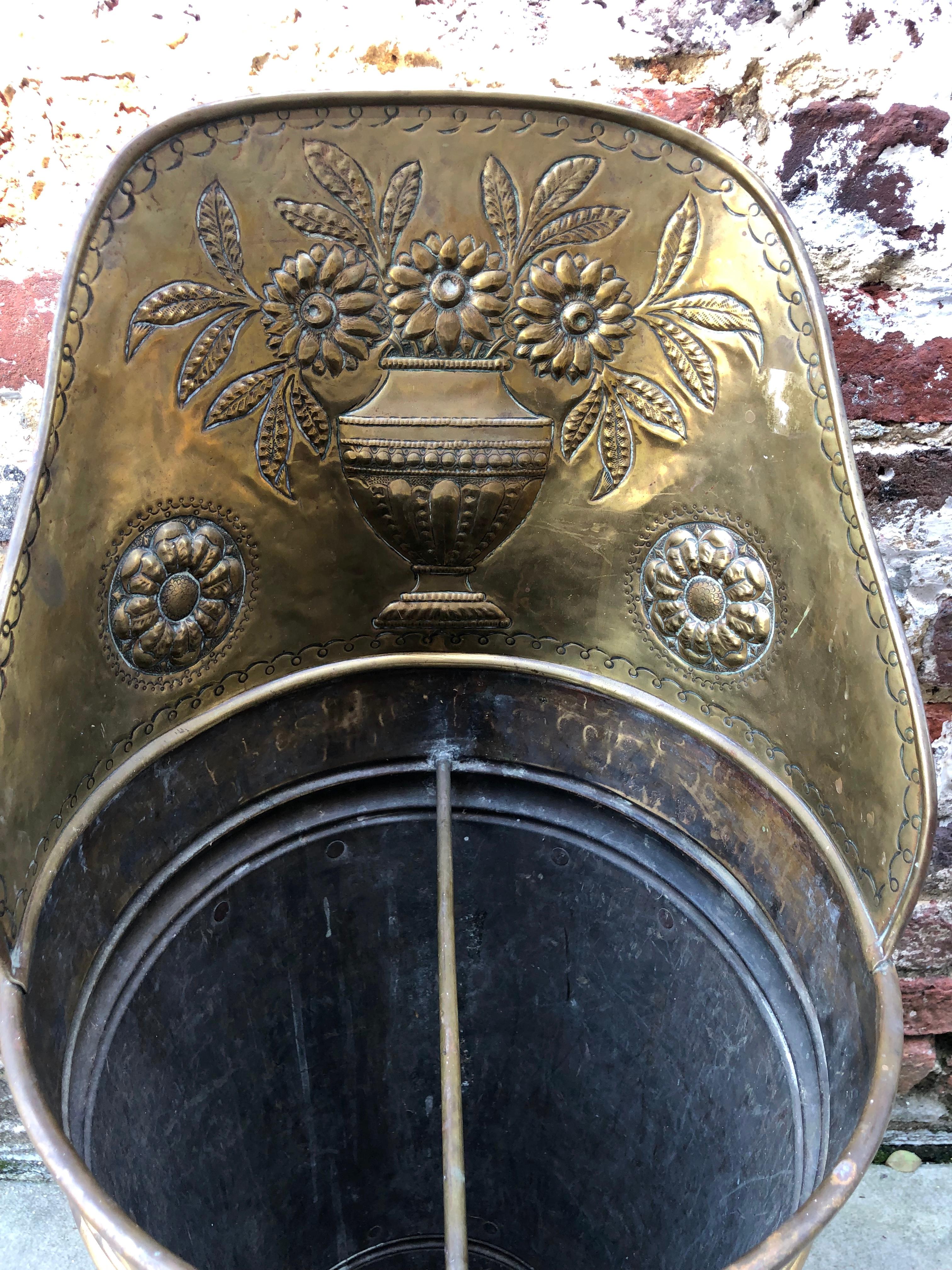 Brass umbrella stand with floral motif. 